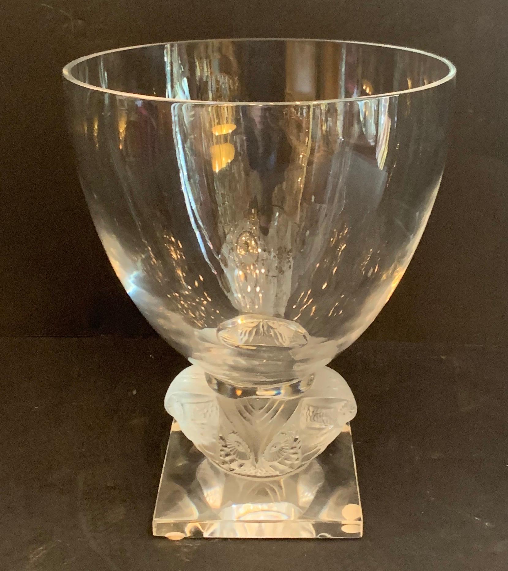 A wonderful large Lalique France frosed and clear crystal Grand Ducs owl vase. This thick clear crystal vase is set on a pedestal embellished with four owls on a square base. Etched to the side of the base is “Lalique France.