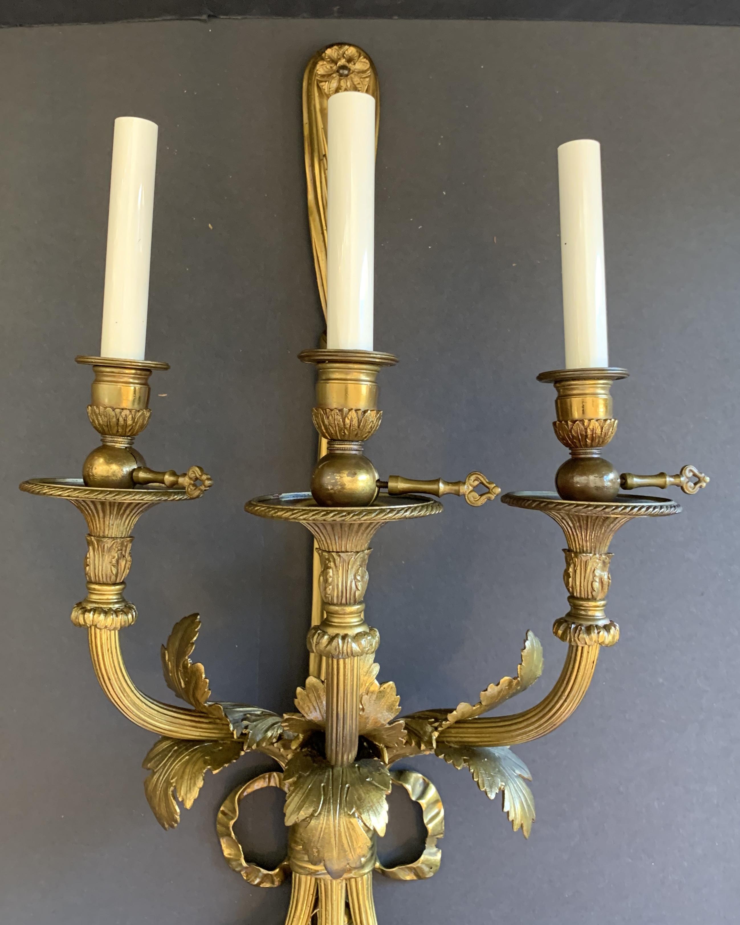 Wonderful Pair of French Bronze Caldwell Three-Arm Ribbon Bow Tassel Sconces In Good Condition In Roslyn, NY