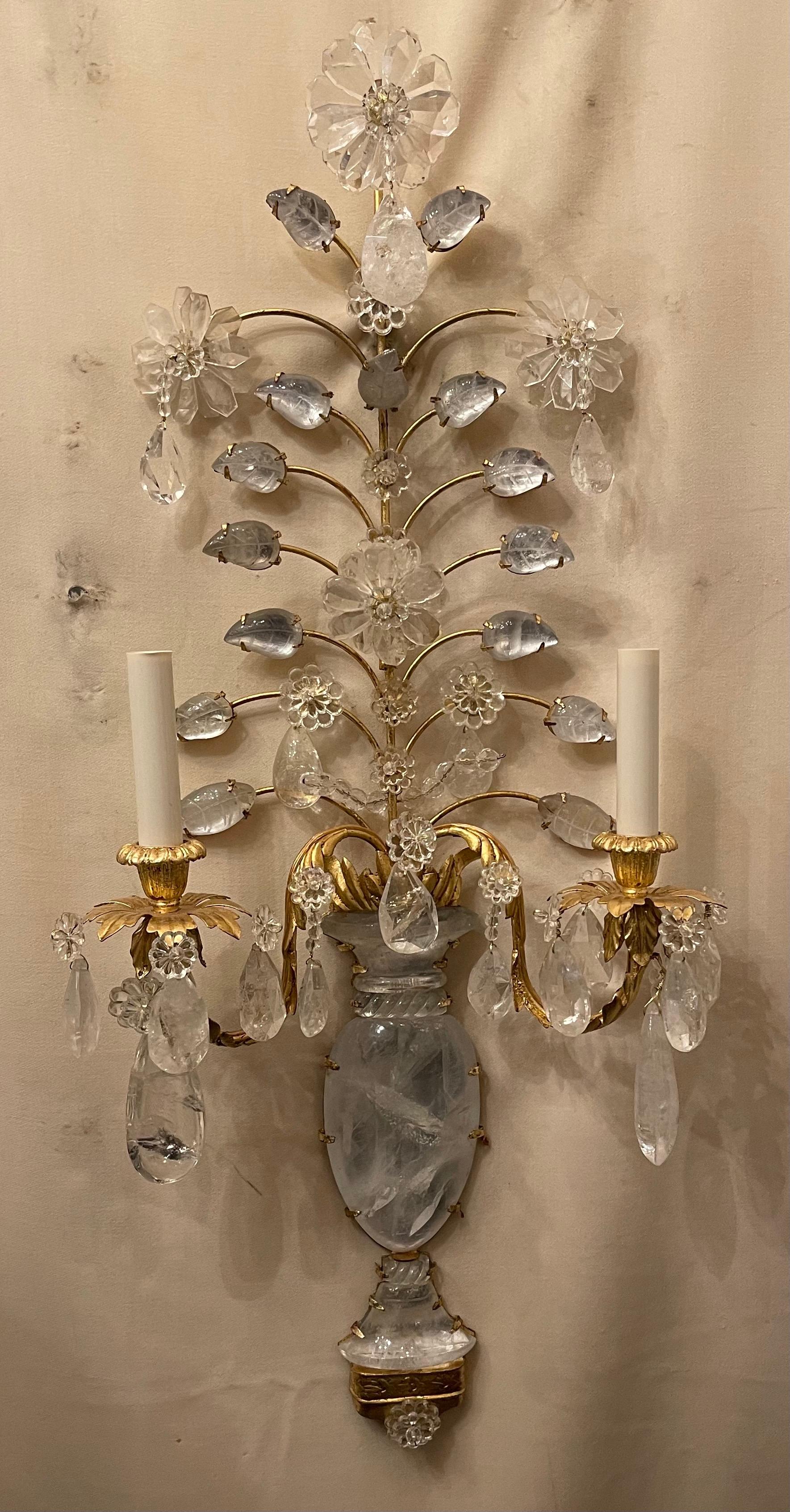 A wonderful pair of two candelabra light french gold gilt and rock crystal flower / urn form Maison Baguès style sconces, they are completely rewired.

Two pairs available.