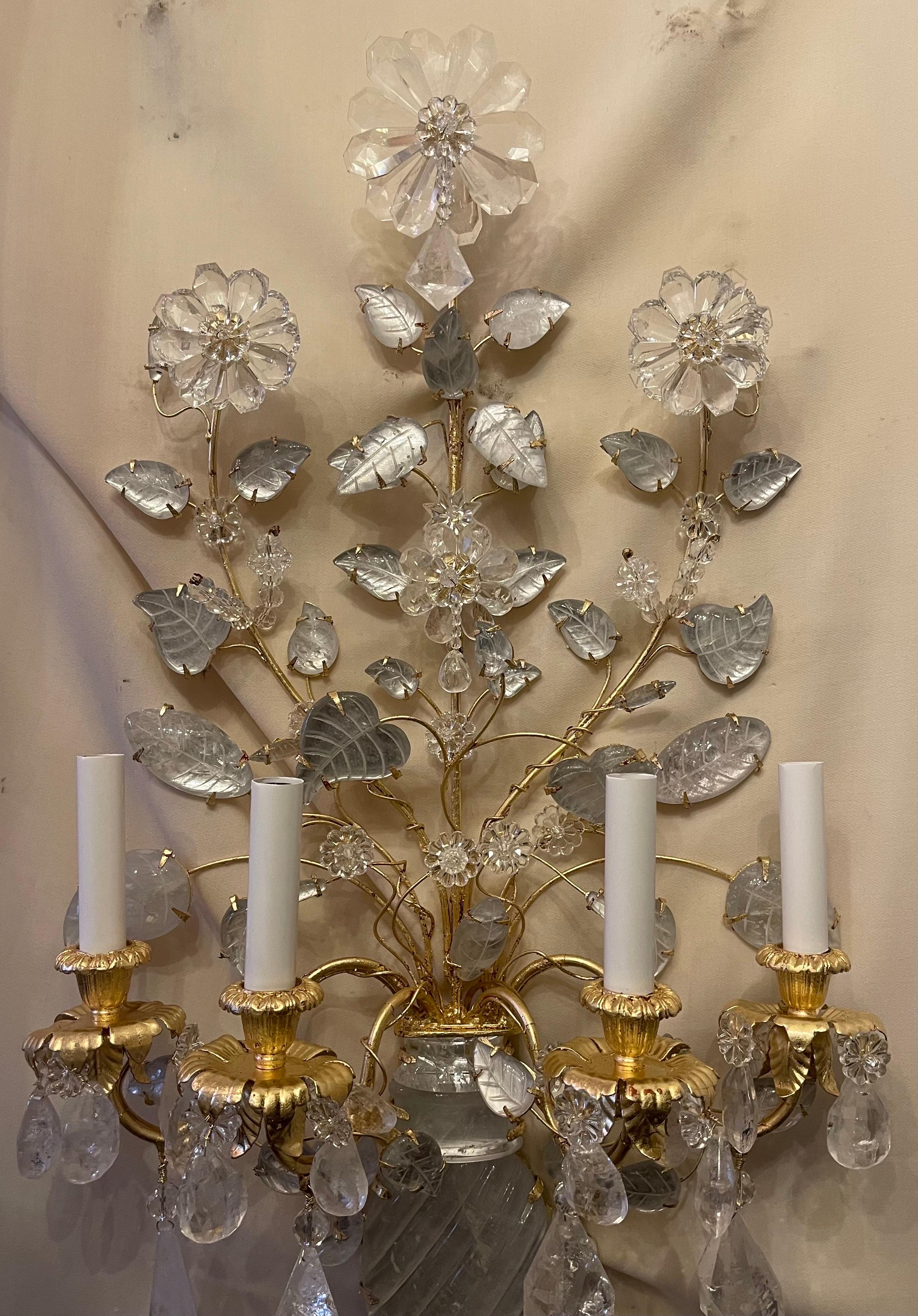 A wonderful pair of four candelabra light French gold gilt and rock crystal flower / urn form Maison Baguès style sconces, they are completely rewired.

Two pairs available