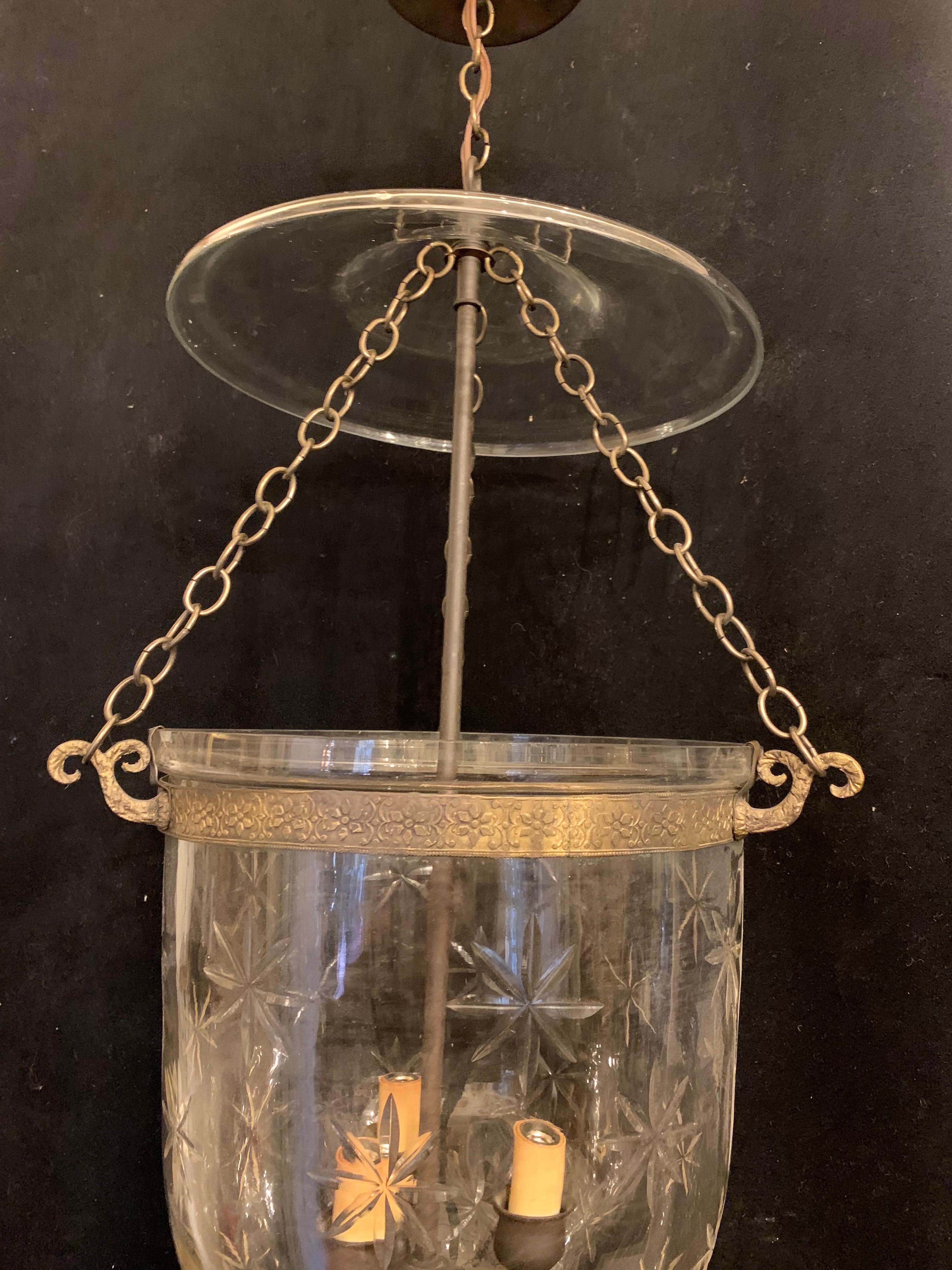 A wonderful large pair of vintage Vaughn star pattern globe bell jar lantern fixtures with patinated bronze finish, each with 3 candelabra sockets.