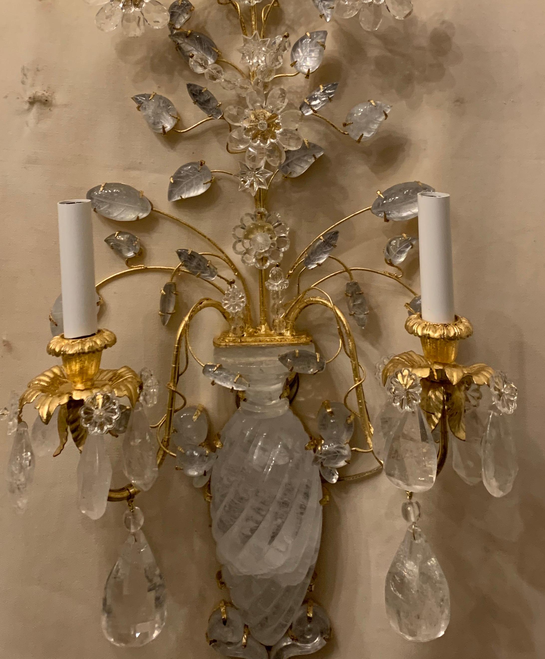 A wonderful large set of four French gold gilt and rock crystal flower / urn form Maison Baguès style sconces, they are completely rewired.

Each pair sold separately, two pairs available.