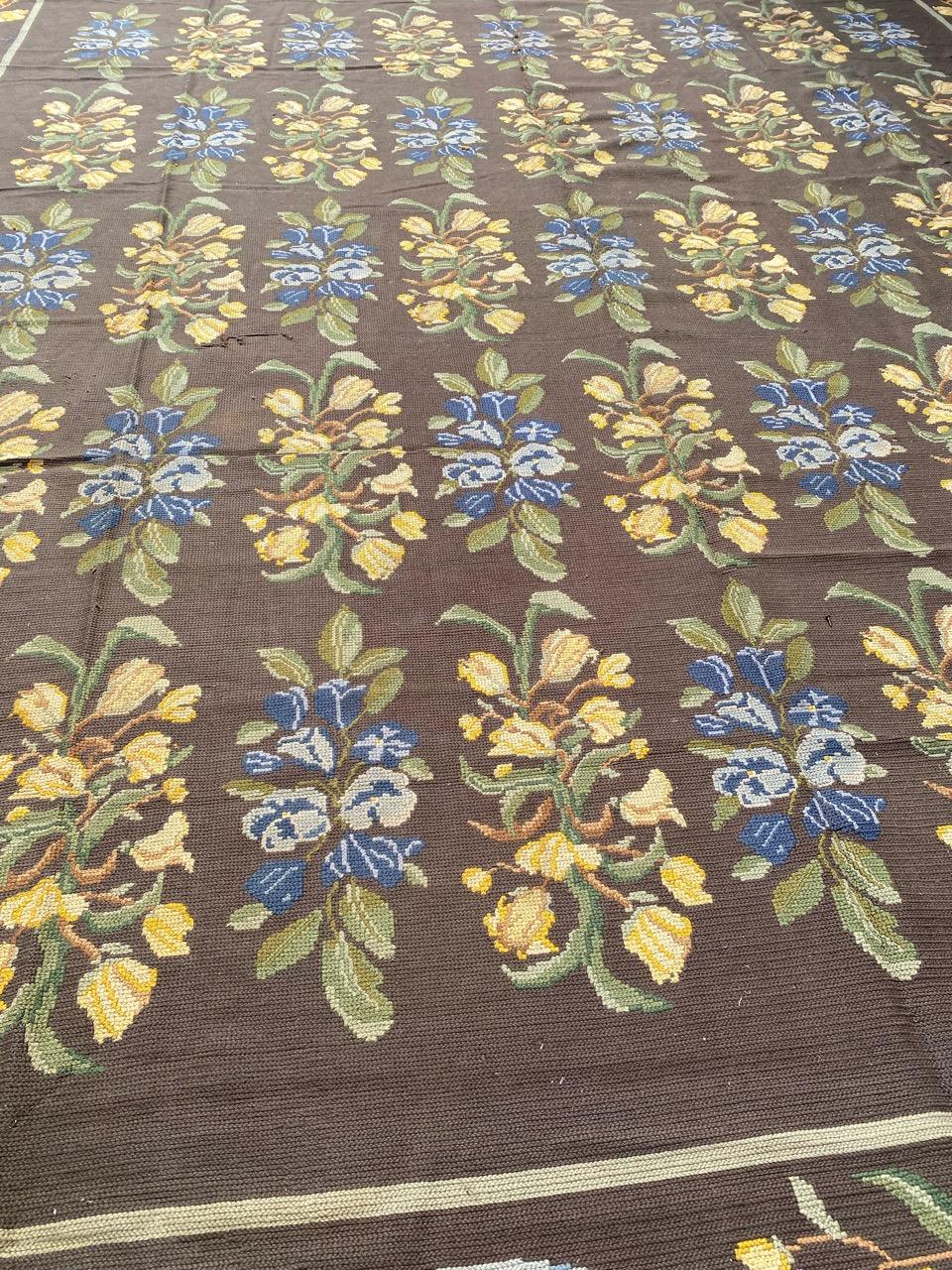 Very beautiful large flat hand embroidered Portuguese needlepoint rug with beautiful floral design and nice colors with a brown field, entirely hand embroidered with wool on jute foundation.