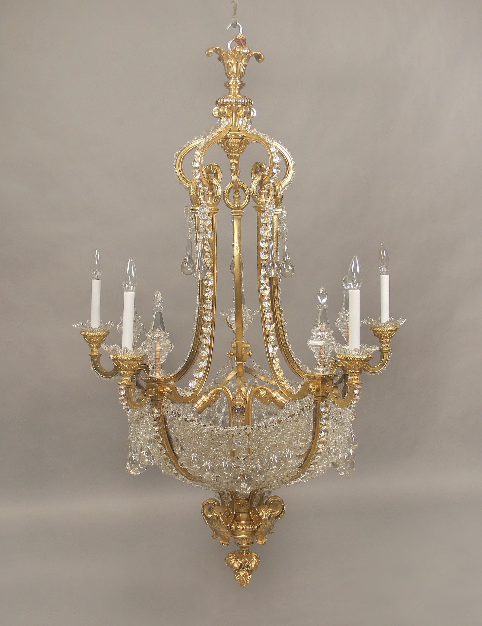 A wonderful late 19th century gilt bronze and beaded net basket ten-light chandelier.

Beautiful gilt bronze casted cage with crystal beaded arms, four cut crystal spears with five perimeter and five interior lights.

 