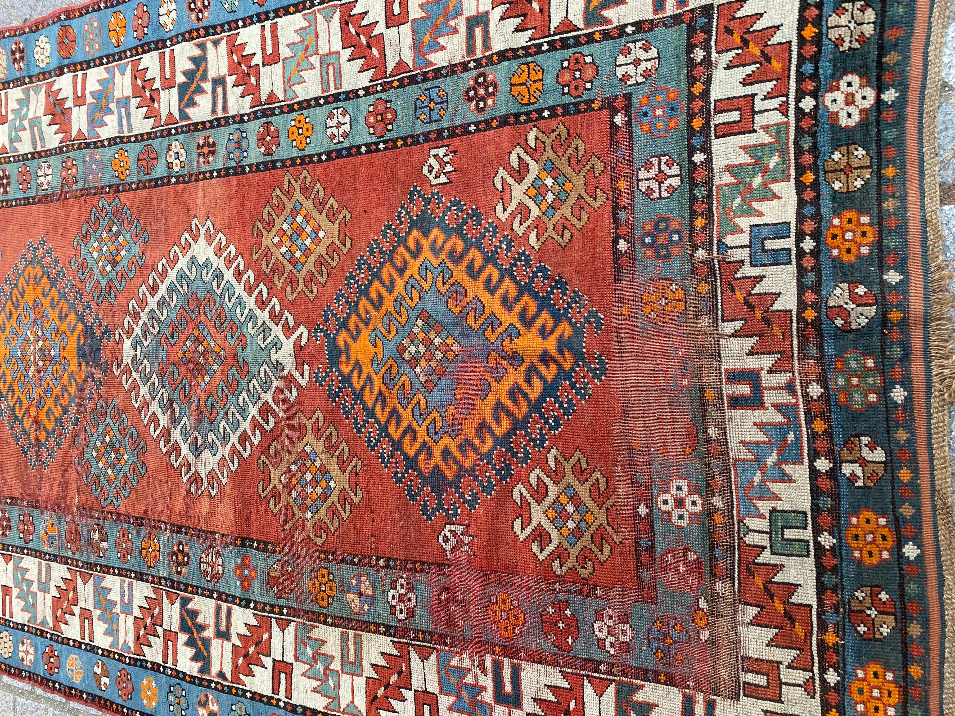 Discover the timeless elegance of our late 19th-century Caucasian runner, a true masterpiece. Immerse yourself in the intricate geometrical design, adorned with vibrant blue, orange, red, and green hues. Meticulously hand-knotted with wool velvet on