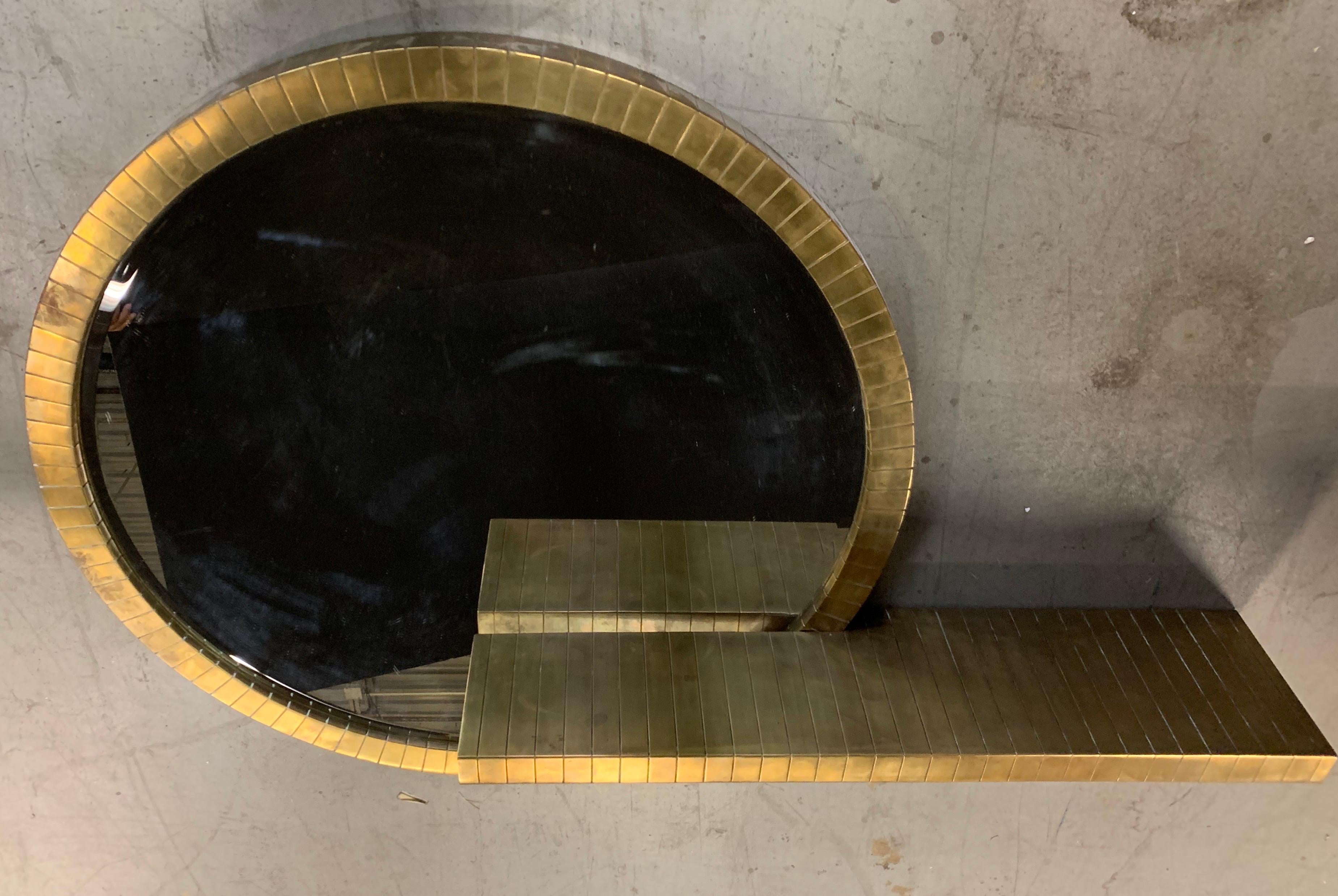 A wonderful Lorin Marsh Mid-Century Modern brass round mirror and wall mounting console titled 