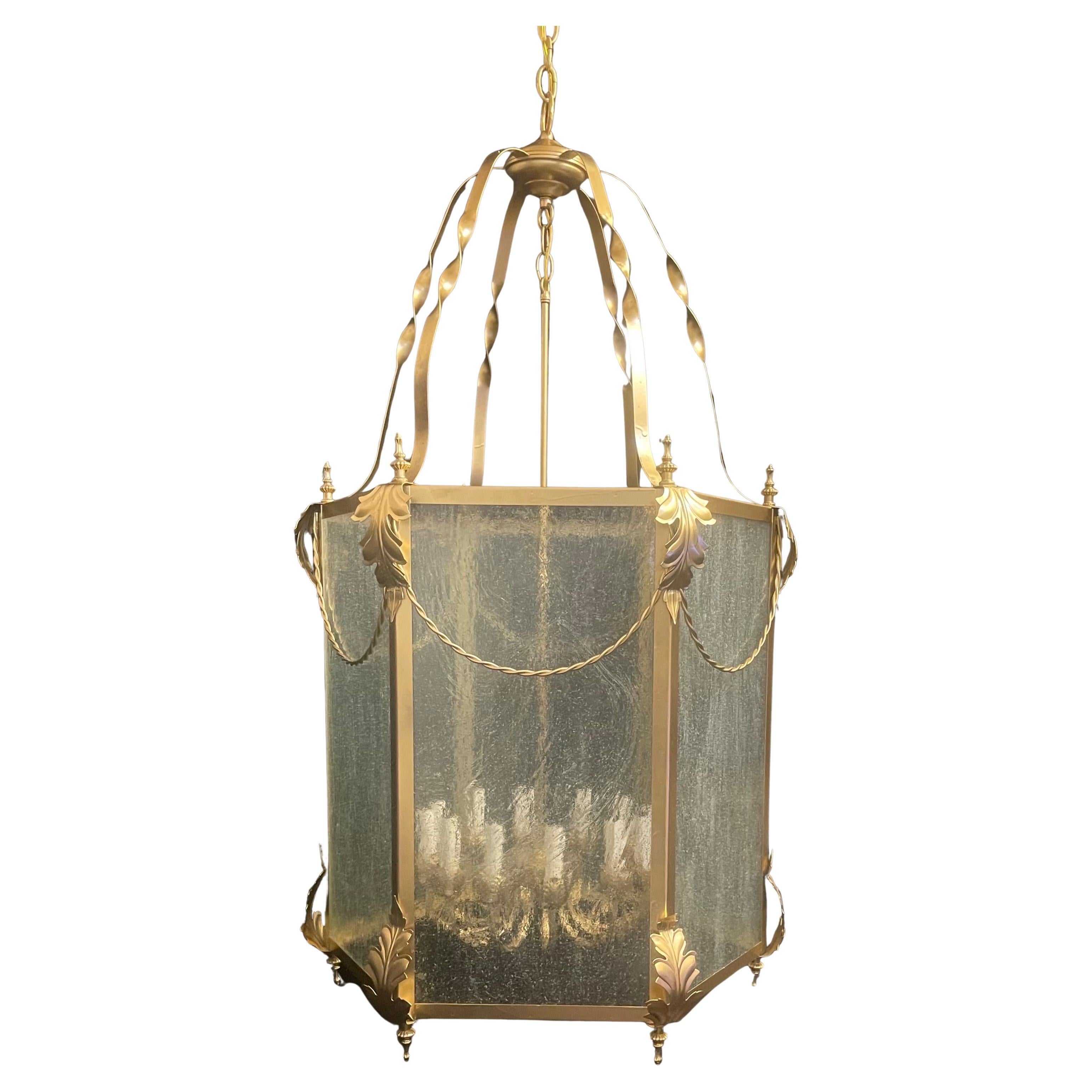 A Wonderful Louis XVI Style Adorned With Leafs & Swags, Large Gold Gilt Lantern Light Fixture Having Seeded Glass Panels. On The Interior 12 Candelabra Light Center Shaft That Has Been Rewired, This Lantern Fixture Comes With Chain And Canopy Ready