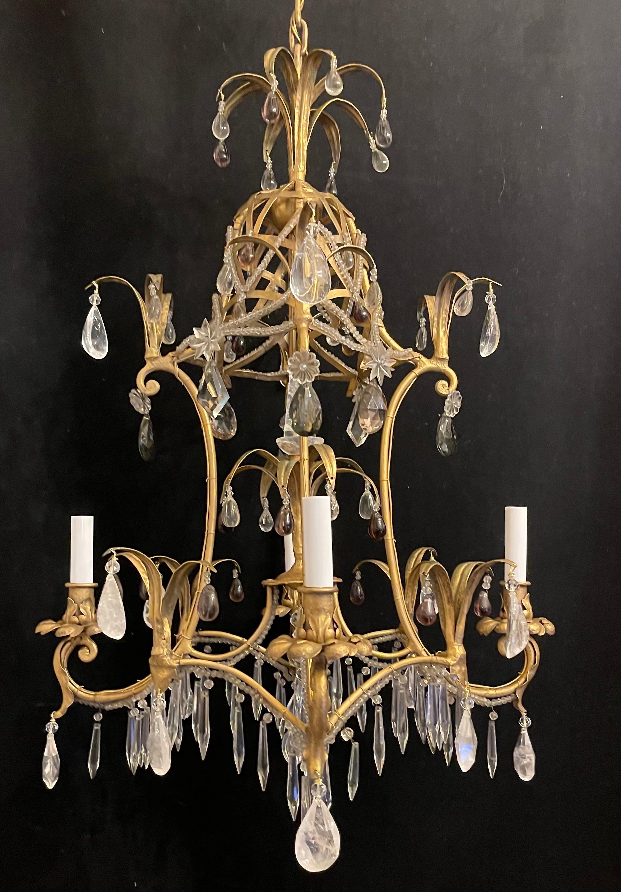 A wonderful Maison Bagues style basket gilt with rock crystal, amethyst & beading in a pagoda form 4 candelabra light chandelier
This fixture has been rewired and comes with chain canopy and mounting hardware for installation.