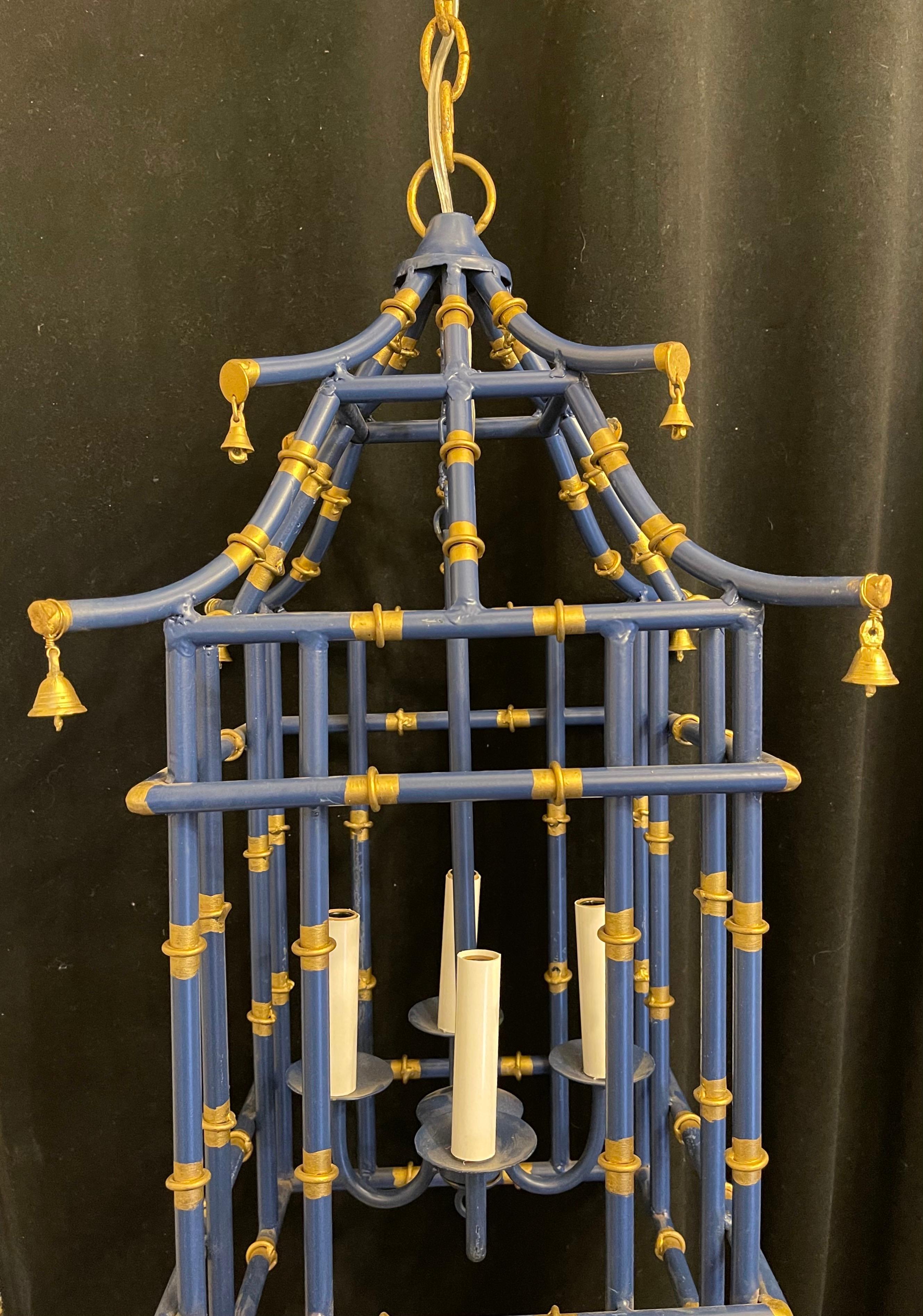 A wonderful pair medium sized navy blue & gold gilt pagoda bamboo form chinoiserie lantern fixtures with a 4 candelabra light clusters
Rewired and ready to install with chain canopy and mounting hardware.

Each sold separately 