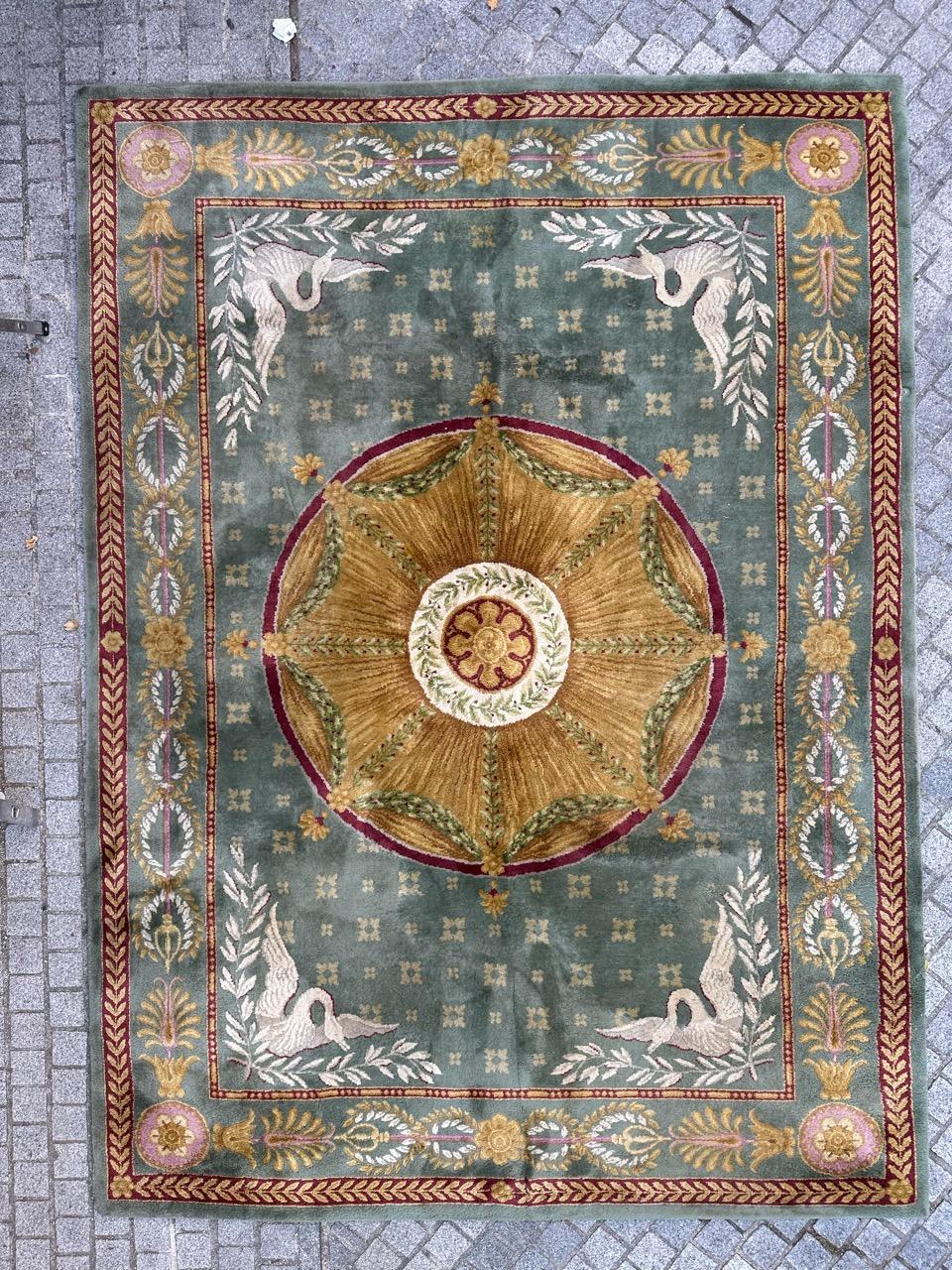 Exquisite large vintage Savonnerie palace rug in the elegant Louis XVI style. This masterpiece features a lush design with a green field, striking yellow and red accents. Meticulously hand-knotted with wool velvet on a sturdy cotton foundation by