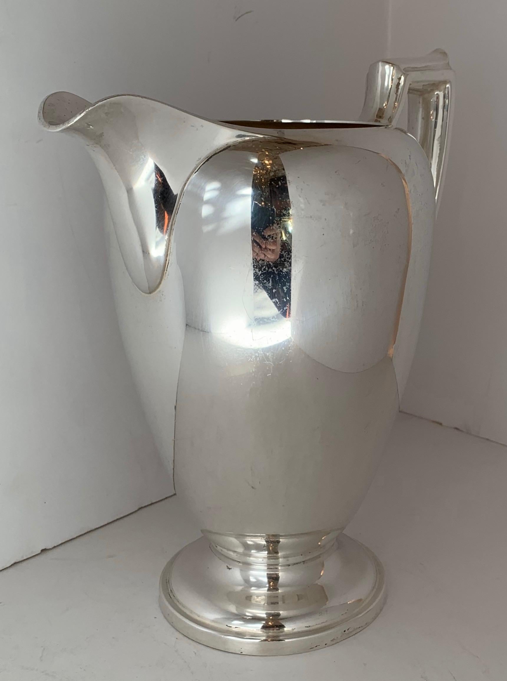 A wonderful Mid-Century Modern Art Deco Cartier sterling silver water pitcher.