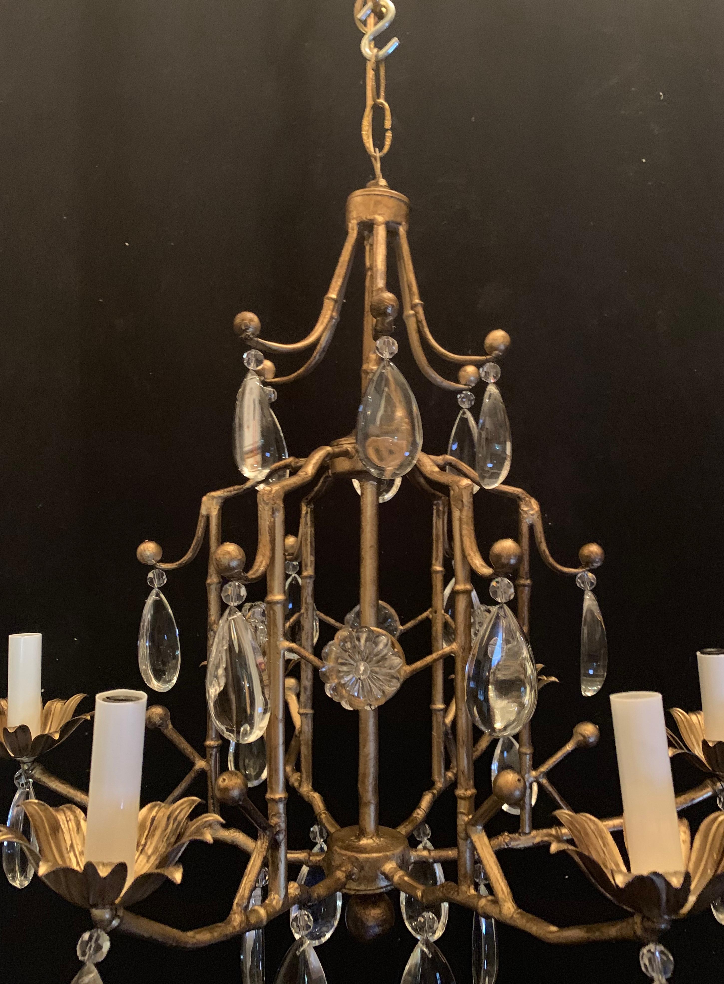 A wonderful Mid-Century Modern Bagues style gilt bamboo cage form and crystal drop chandelier with 6 candelabra lights.