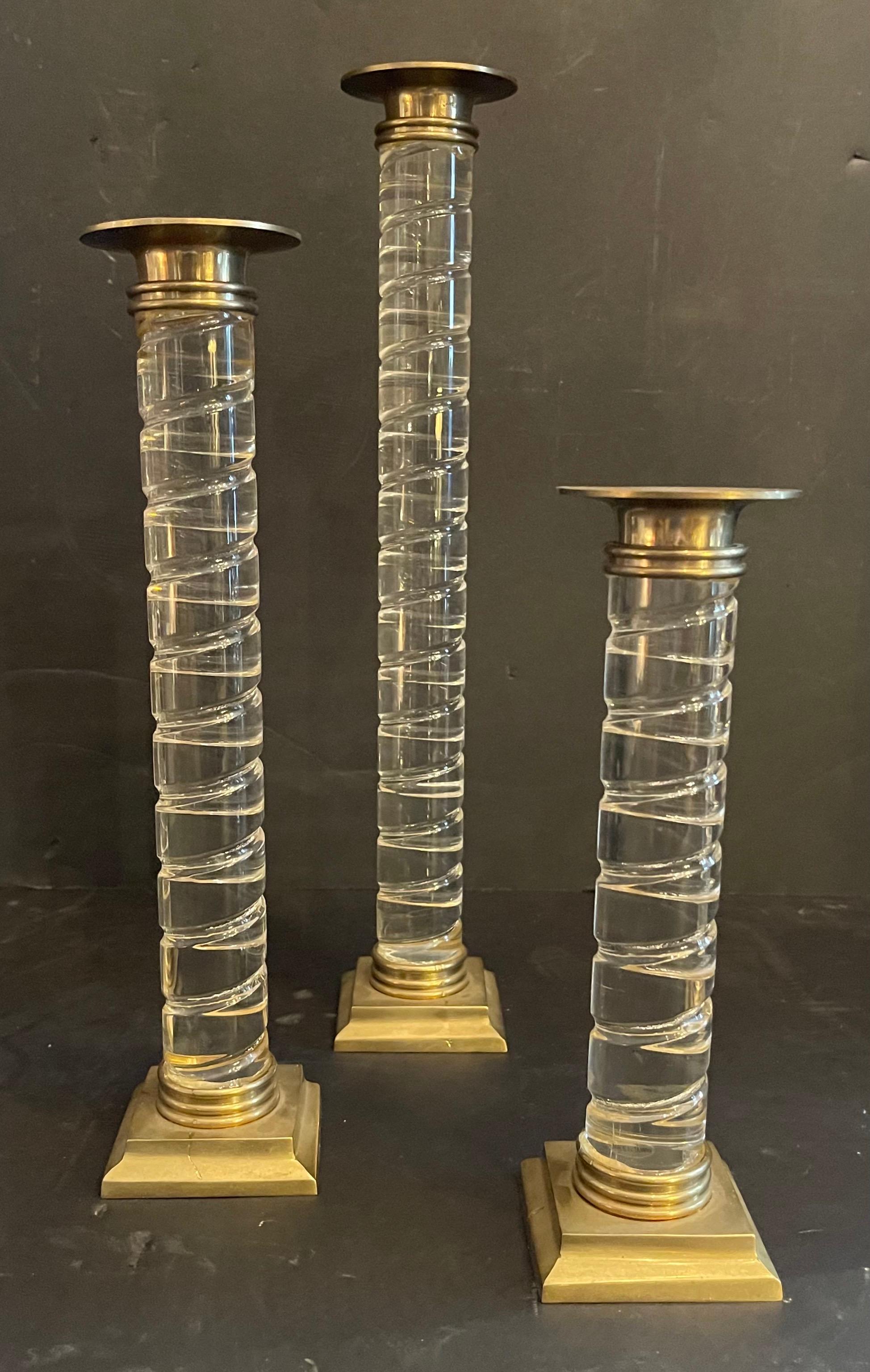 A wonderful set of three Mid-Century Modern Lorin Marsh Murano clear swirl Lucite with brass base and top candlesticks.