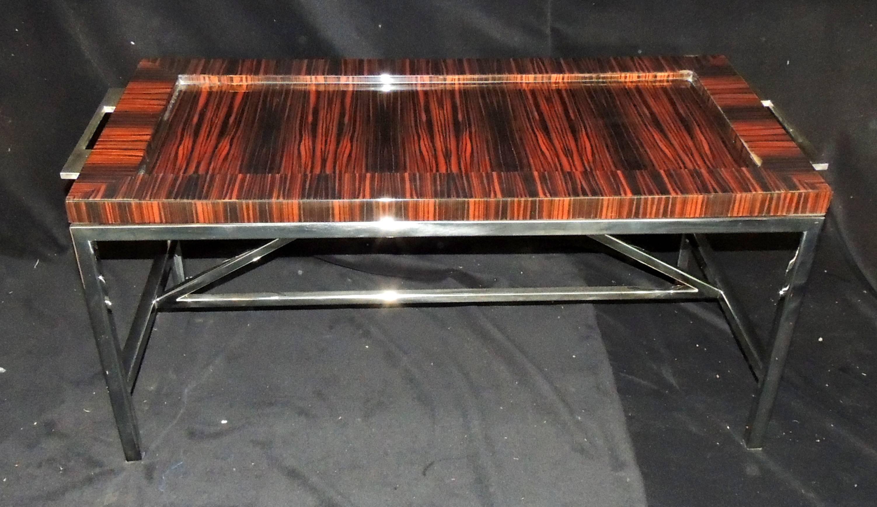 A wonderful midcentury Macassar ebony and polished nickel base and side handle, Art Deco style removable tray top coffee table. Purchased from Lorin Marsh.
Top of table has minor finish blemish.
Measure: 42 1/2
