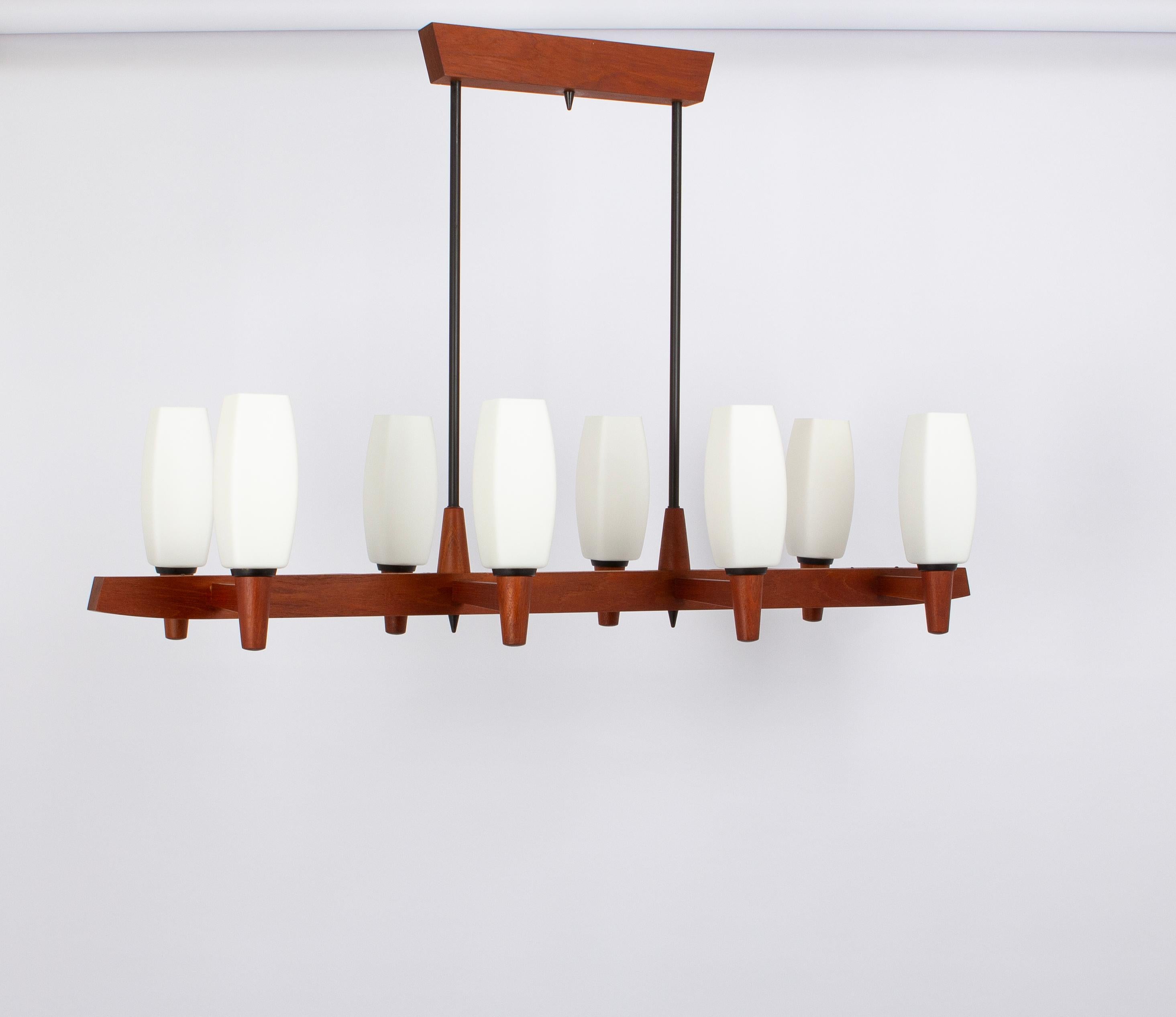 A wonderful midcentury teak chandelier. A unique, timeless and elegant masterpiece of Danish Teak wood designed by Kaiser Leuchten, Germany, 1960s. The light sculpture impresses with clear lines and perfect craftsmanship of the materials wood and