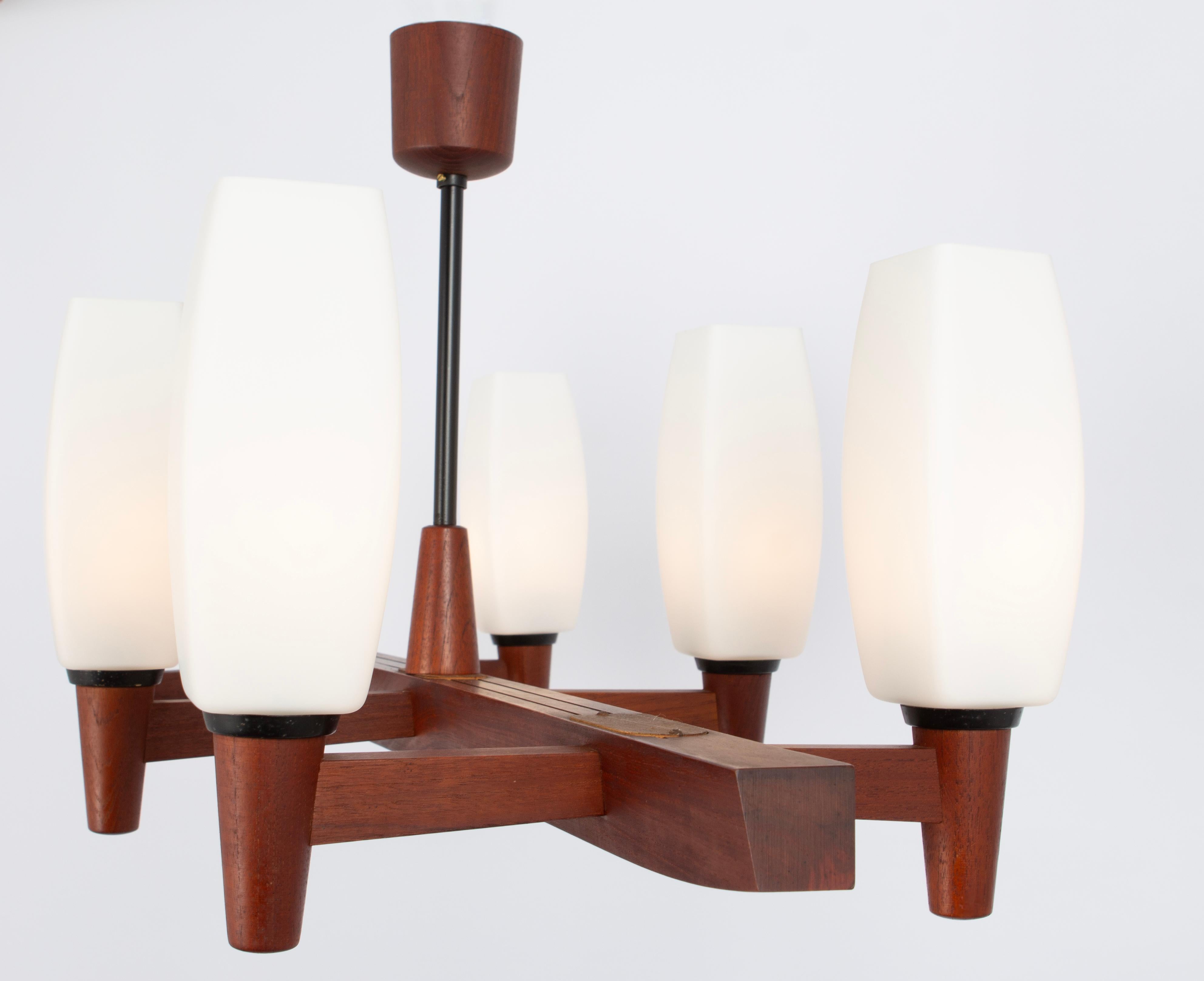 A wonderful midcentury teak chandelier. A unique, timeless and elegant masterpiece of Danish Teak wood designed by Kaiser Leuchten, Germany, 1960s. The light sculpture impresses with clear lines and perfect craftsmanship of the materials wood and