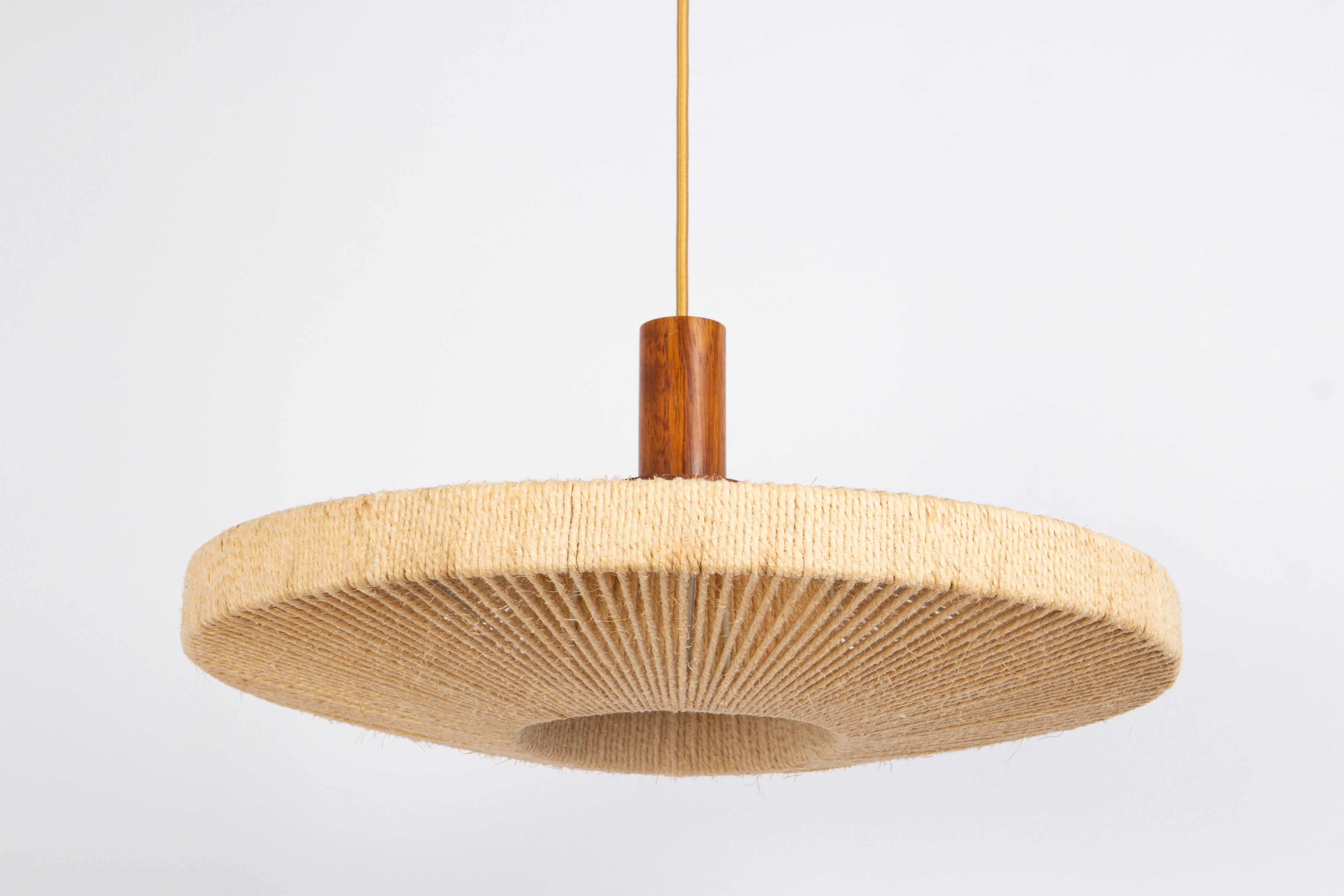 A wonderful midcentury teak chandelier. A unique, timeless and elegant masterpiece of Danish Teak wood designed by Temde Leuchten, Switzerland, 1960s. Danish modern Pendant lamp in solid teak with shade woven with jute/hemp cords/string. Gives off a