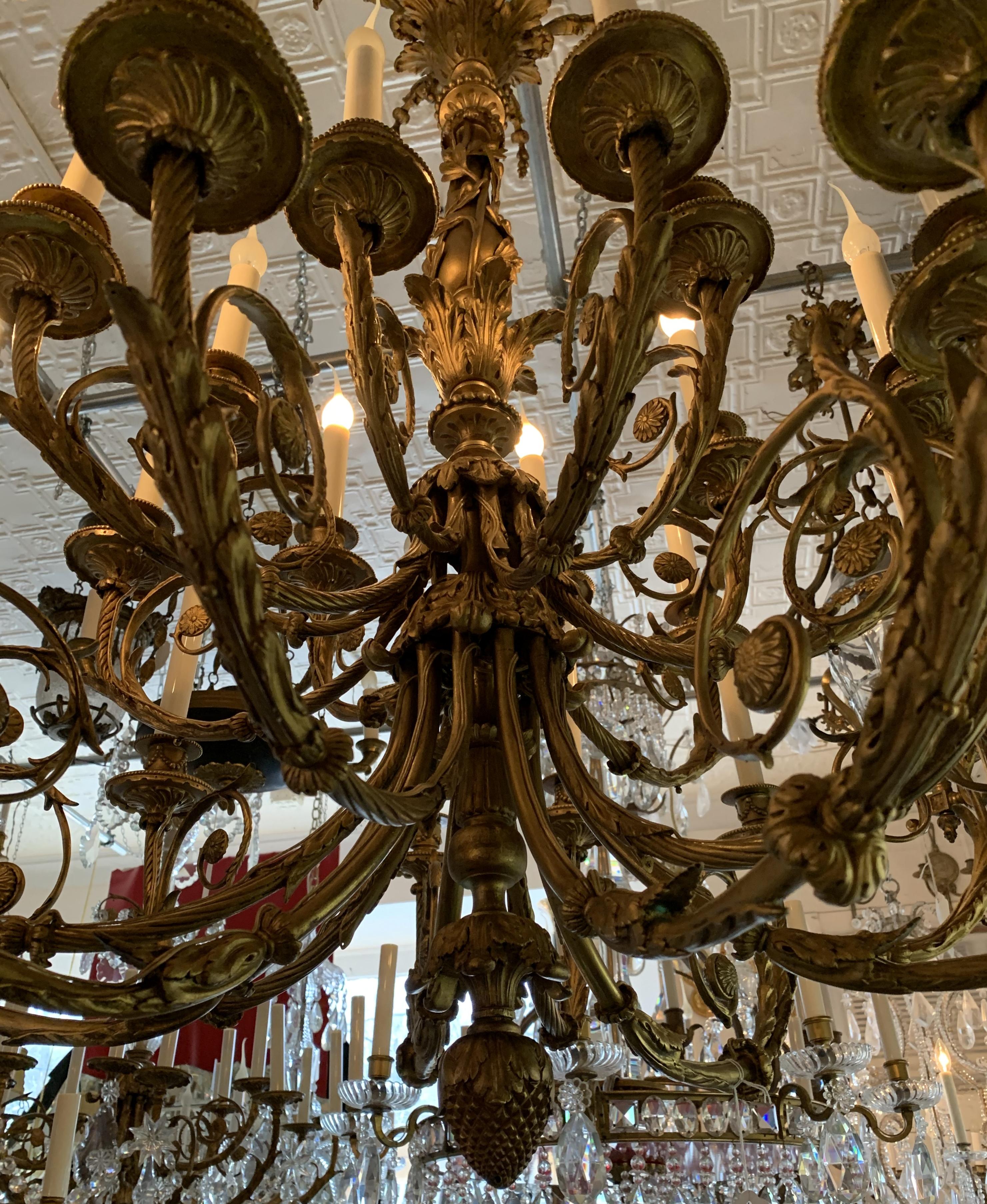 A wonderful monumental 19th century French Regency bronze 24-light two-tier chandelier
Completely rewired and ready to enjoy with chain, canopy and mounting hardware.

Actual chandelier without chain 44