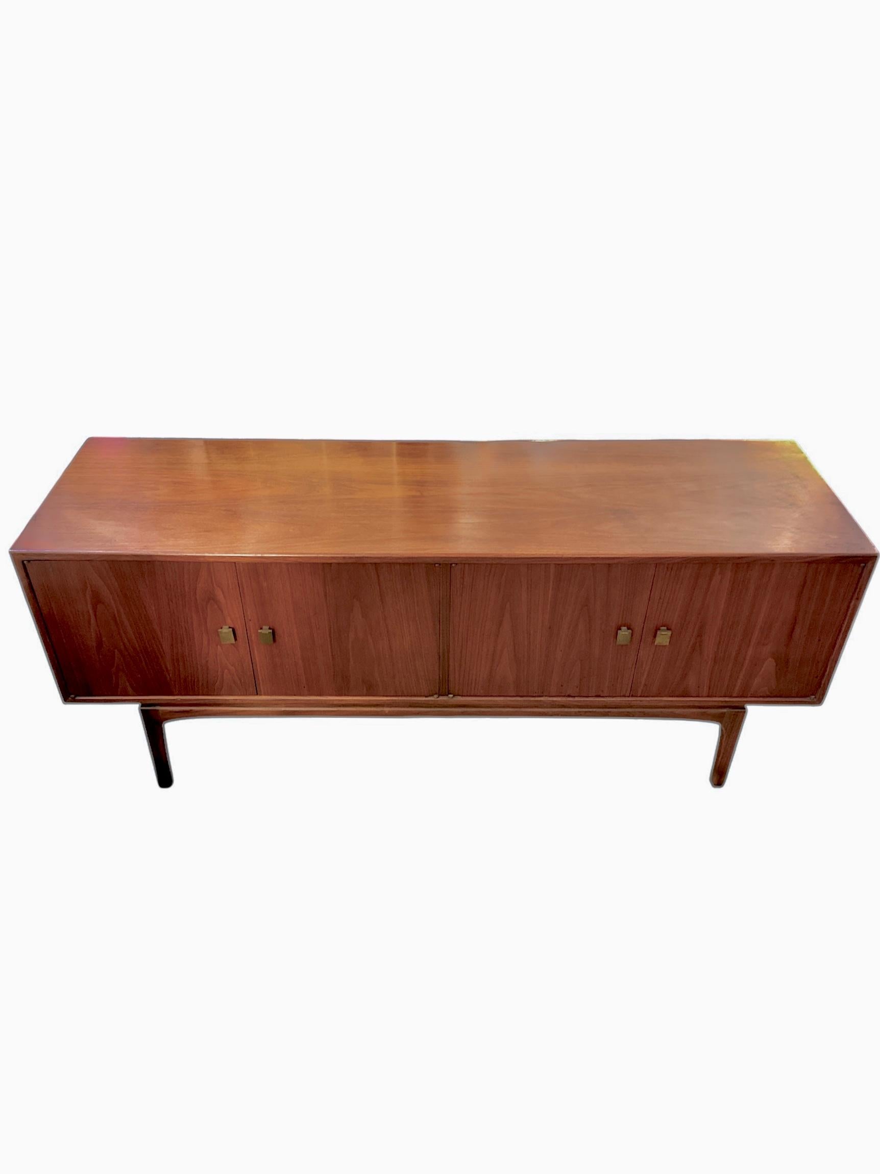 Sleek, timeless, and beautifully crafted, this Mid-Century Credenza from the Motif Series by Thomasville exemplifies the elegance of 1960s modern design. Made from rich walnut with a warm, lustrous finish, this piece features clean lines, subtly