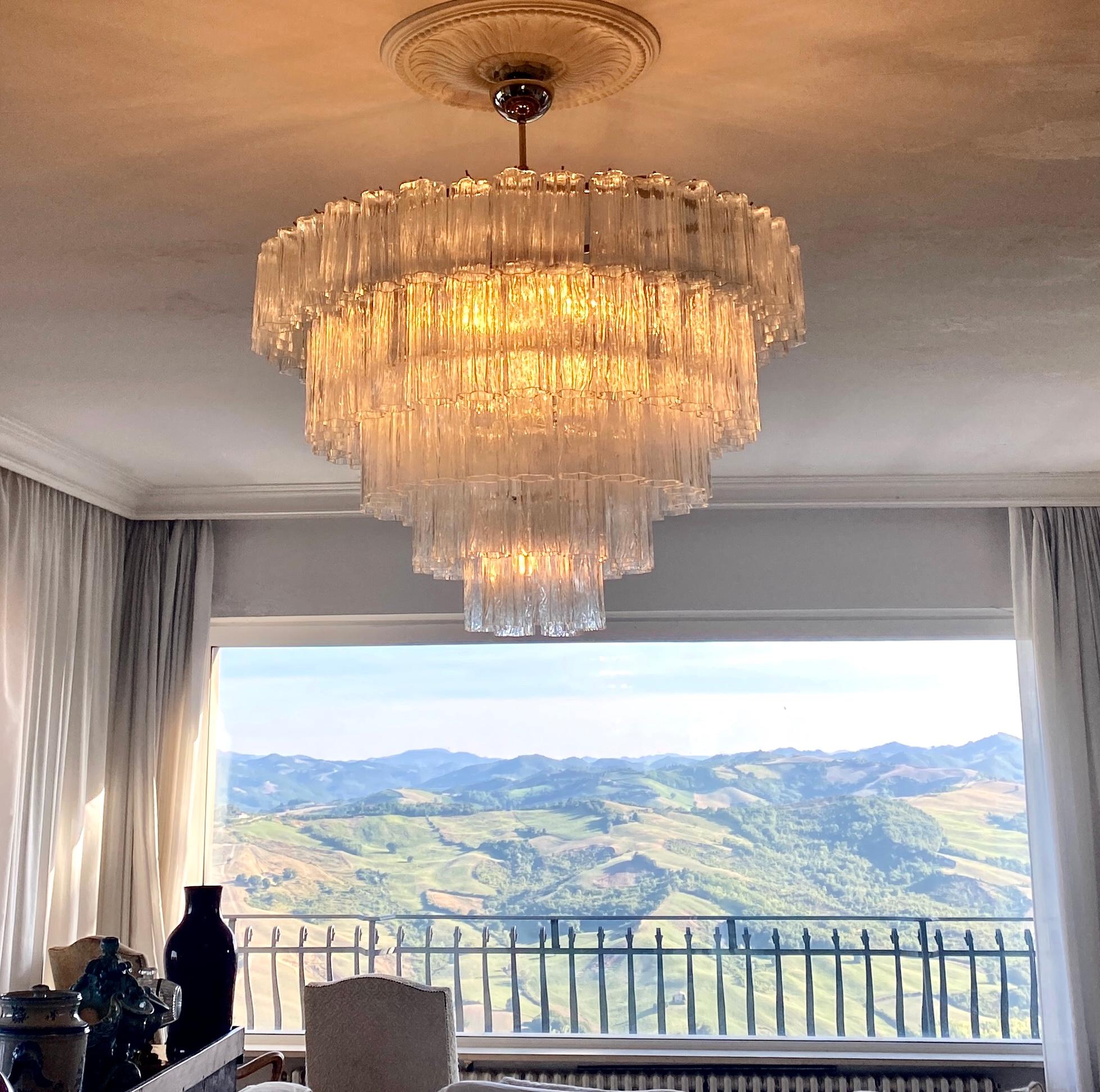 Spectacular chandelier composed by circa 100 tronchi hand blown cylindrical glass pieces in the manner of Tony Zuccheri for Venini.
Adjustable height, by removing or adding chain links.
12 E 14 light bulbs. We can rewire for your country standards.
