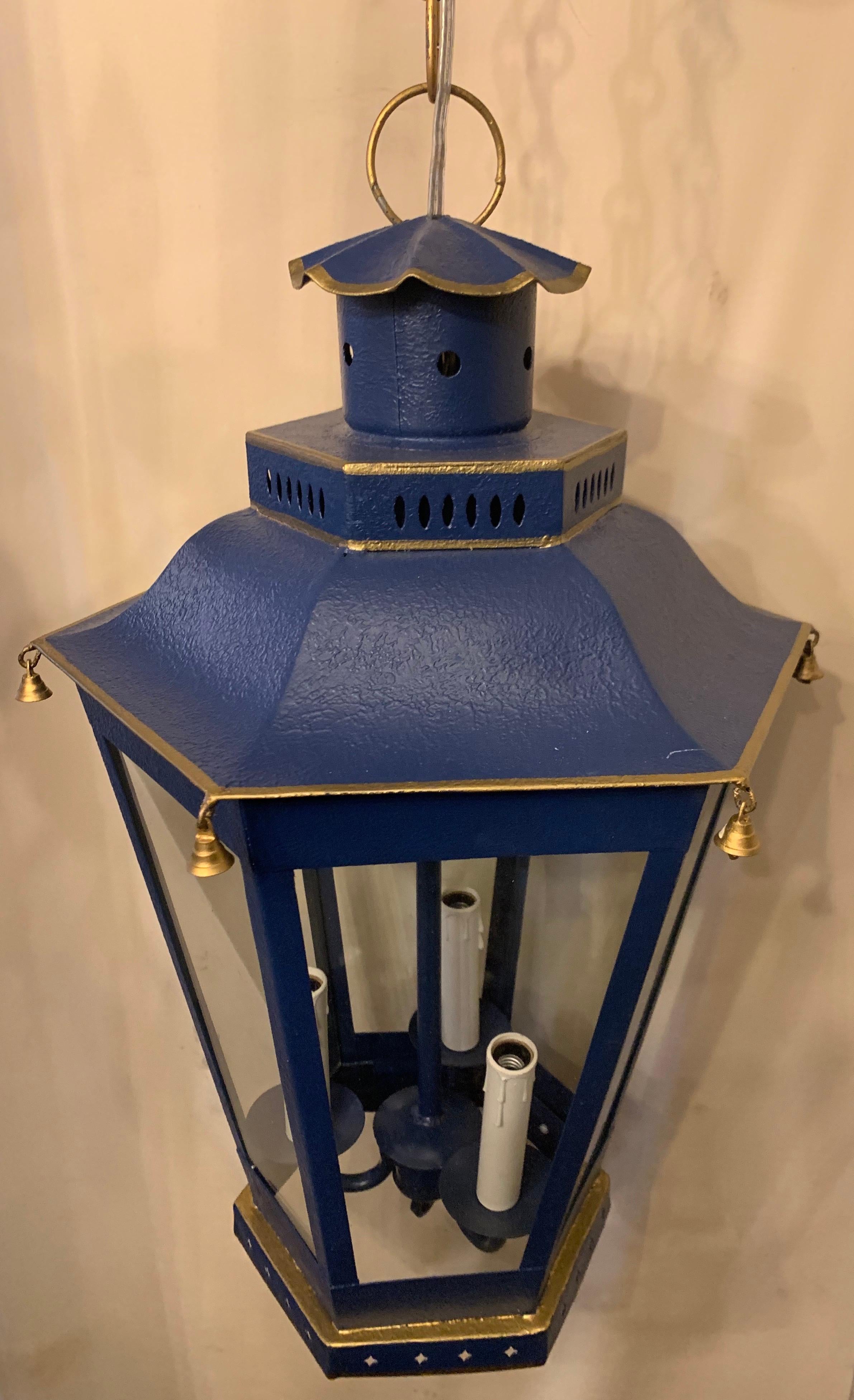 A wonderful navy blue and gold gilt trim pagoda hexagon form glass panel 3 light lantern chinoiserie fixture rewired and ready to install with chain canopy and mounting hardware.