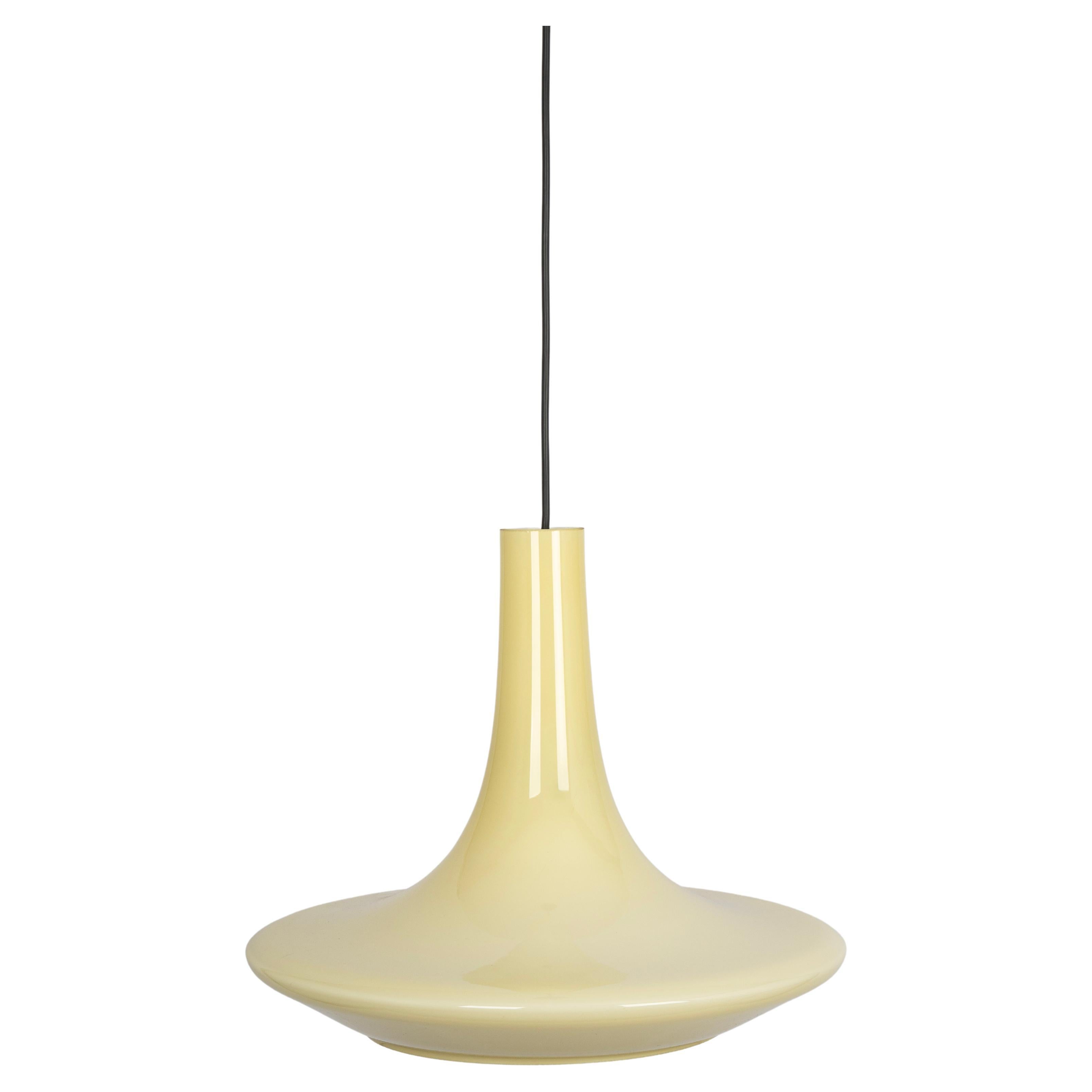 A special form of opal glass pendant designed by Koch & Lowy for Peill & Putzler, manufactured in Germany, circa 1970s.
Beige color cased on opal glass.
This pendant light is more than just a source of illumination; it is a work of art that elevates