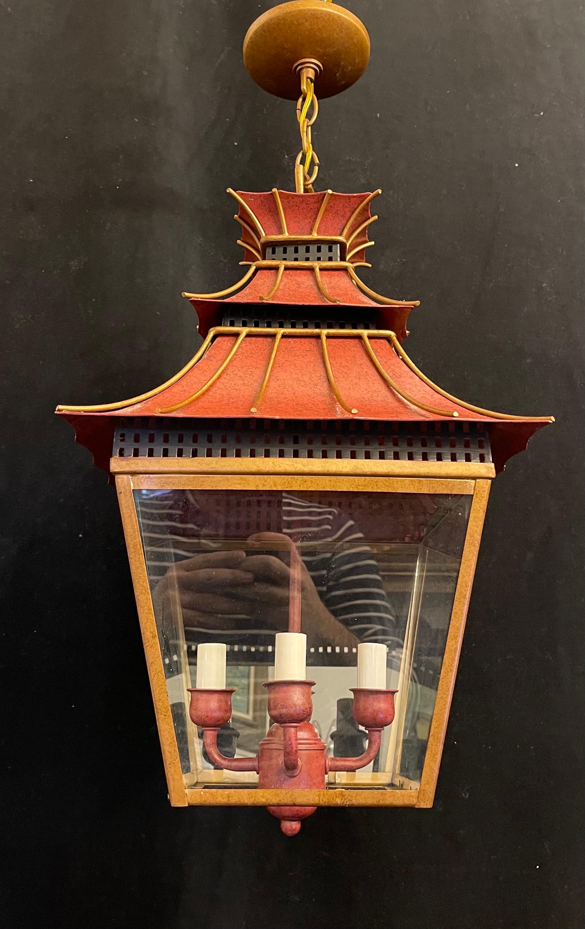 A wonderful vintage hand painted tole orange / red with gold gilt pagoda square glass panel 4 candelabra light chinoiserie form lantern fixture.