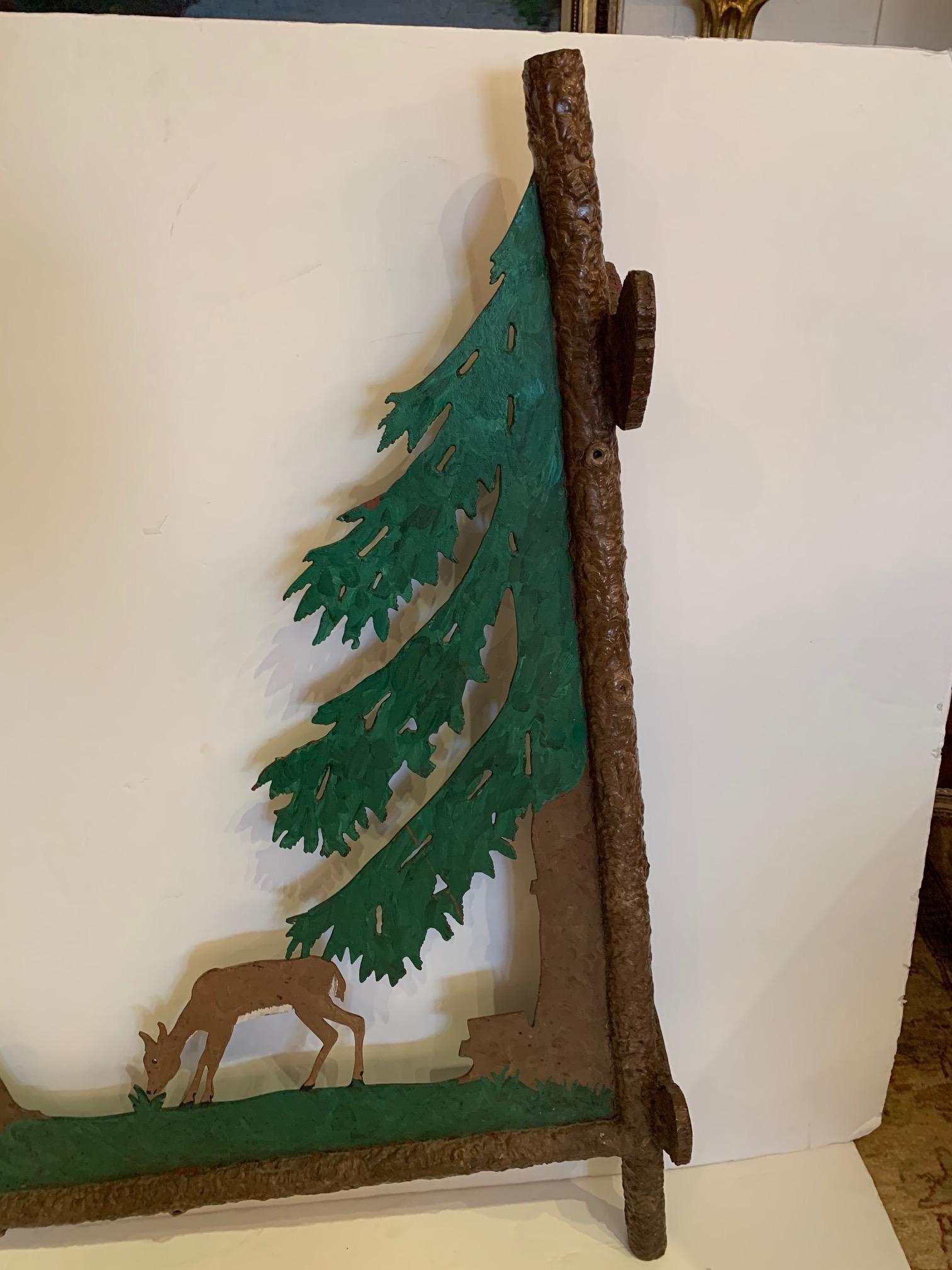 A rare find in a large found object sign, having heavy iron two sided painted decorative scene with evergreen and two bucolic deer.