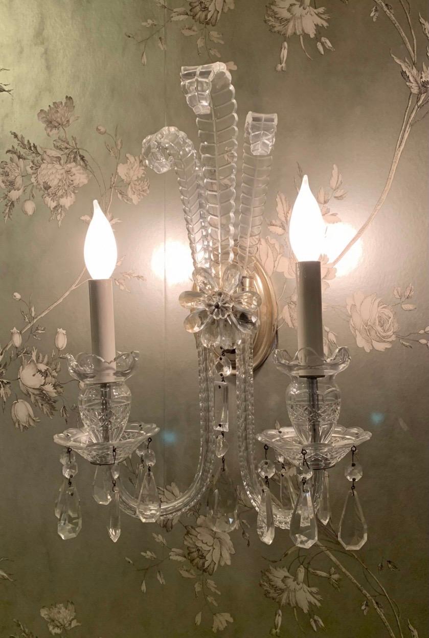 A wonderful pair of antique cut crystal Georgian style silvered bronze two light sconces with three palm leaves cascading over a floral medallion, the sconces are rewired and ready to install.