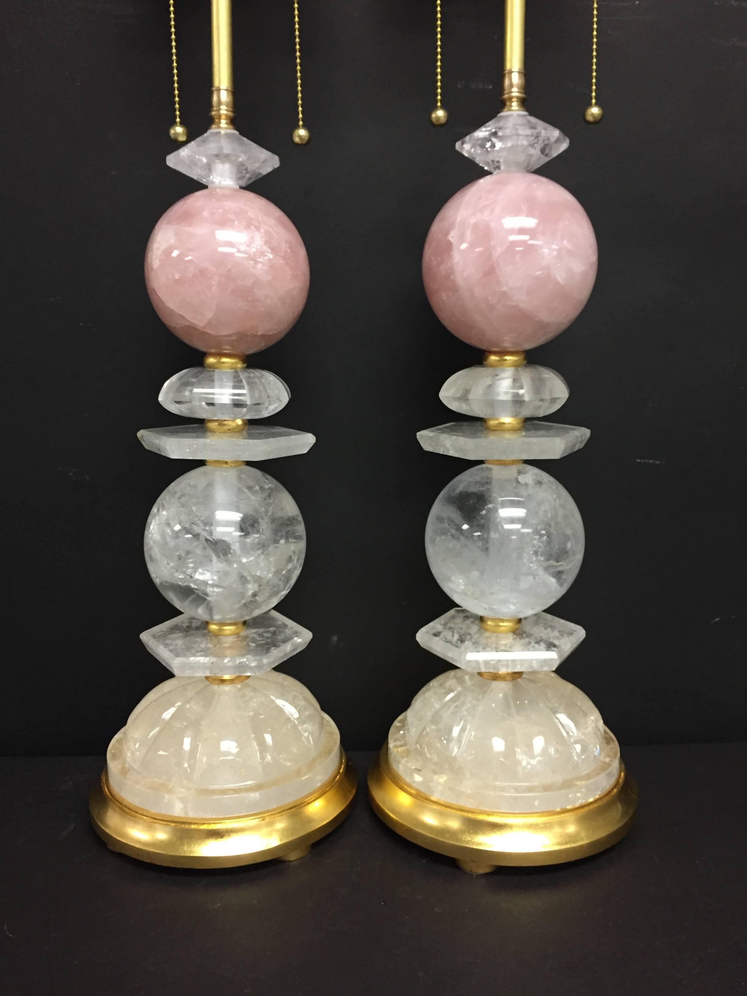 A wonderful pair of Bagues Mid-Century Modern style rock crystal and rose quartz table lamps on gold gilt wood bases, rewired with 75 watts per socket.