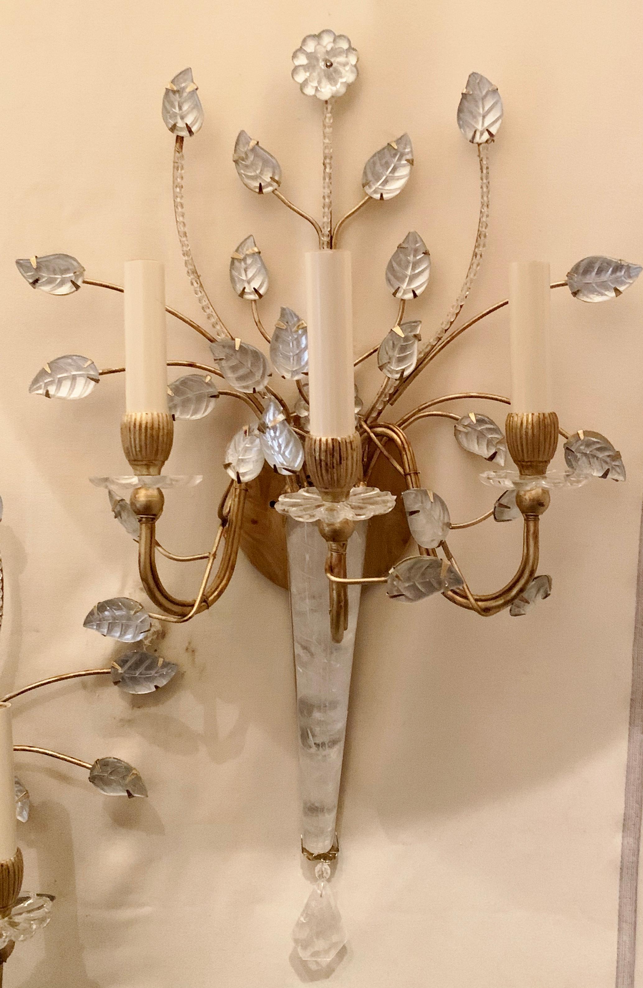 A wonderful pair of Baguès style rock crystal flower and leaf spray form beaded gold gilt sconces. Wiring has been updated and come ready to install and enjoy.