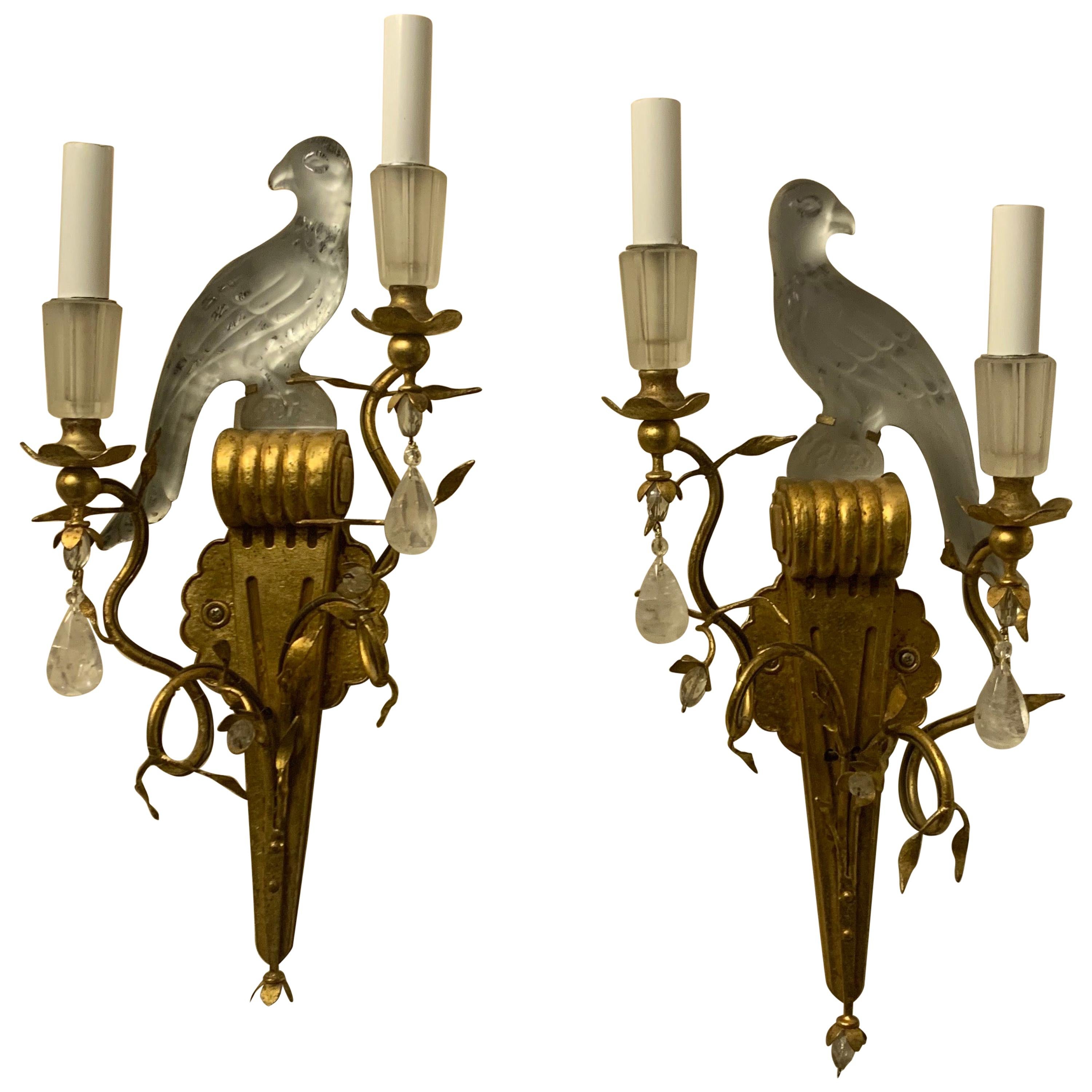 A wonderful pair of Baguès style Sherle Wagner two-arm gold gilt rock crystal drop and crystal bird urn and leaf form sconces.


 