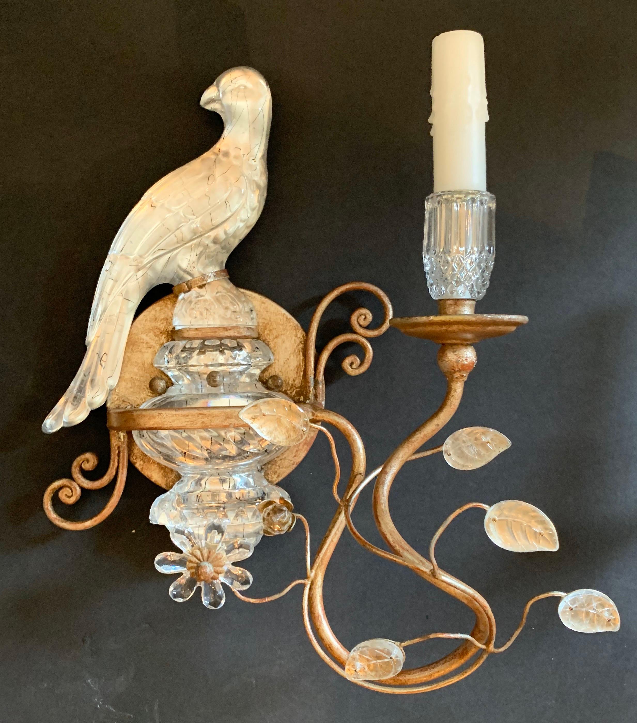 This endearing pair of Baguès style vintage silver and gold wash gilt and faux rock crystal sconces are beautifully balanced with leaves and the crystal urn the bird sits on. There is a right and left facing bird.

Completely rewired with