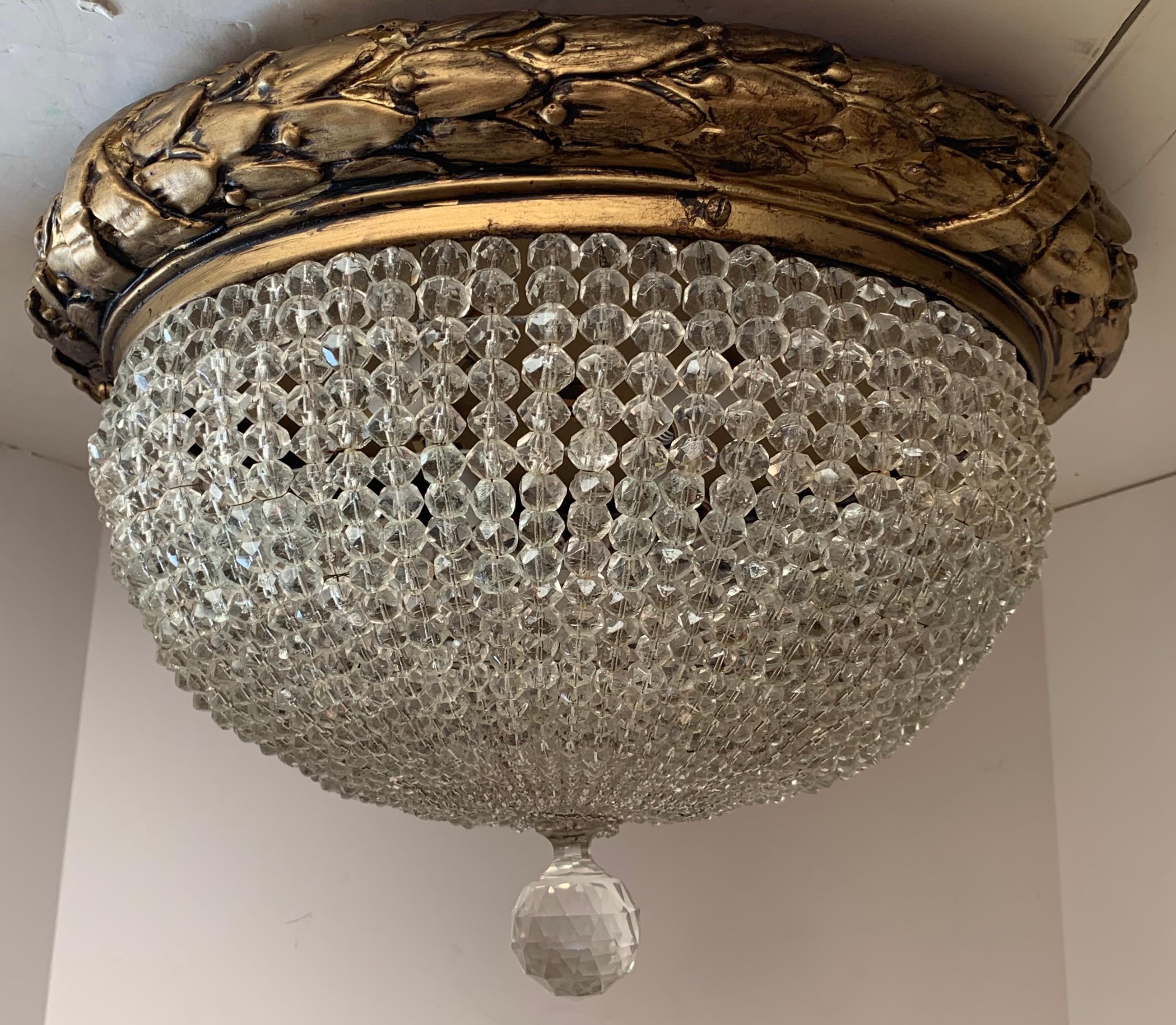 A wonderful pair of beaded crystal and gold gilt composition flush mount ceiling fixtures each with 4 new candelabra sockets and wiring

Each chandelier sold separately.