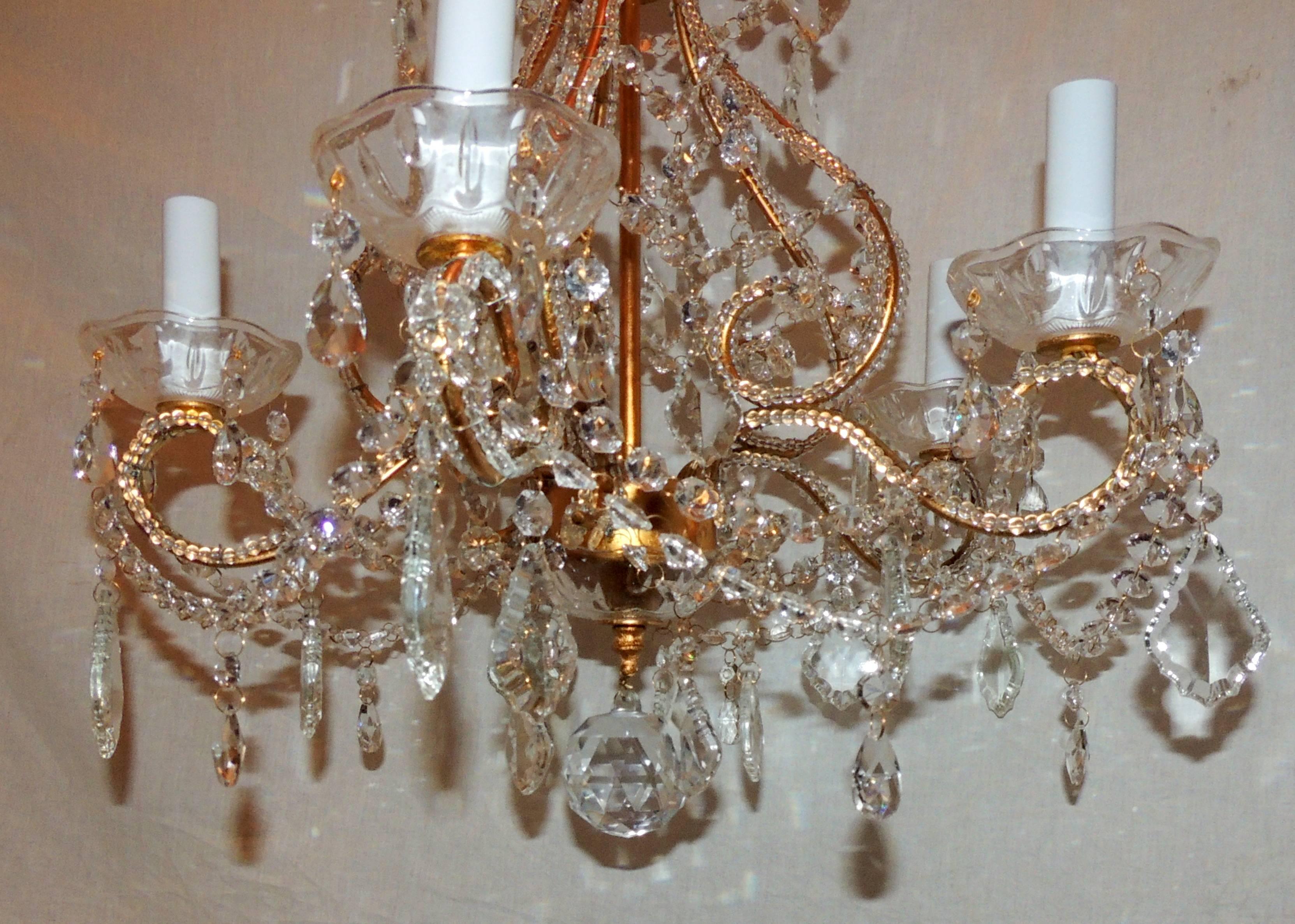 A wonderful pair of beaded gold gilt, Italian crystal chandeliers with five-light each.
Sold separately.
