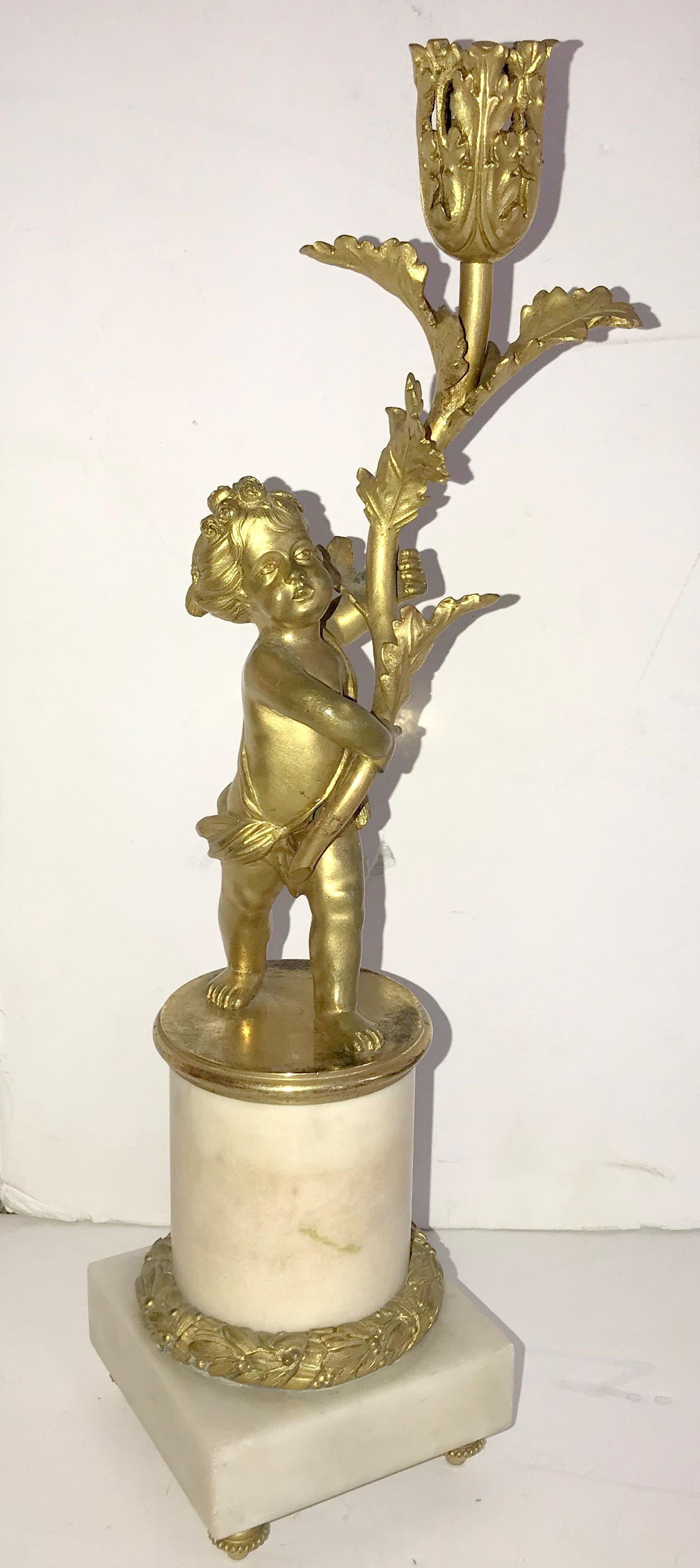 A wonderful pair of Cherub doré bronze / putti figure pierced candelabra with ormolu mounts raised on marble bases.