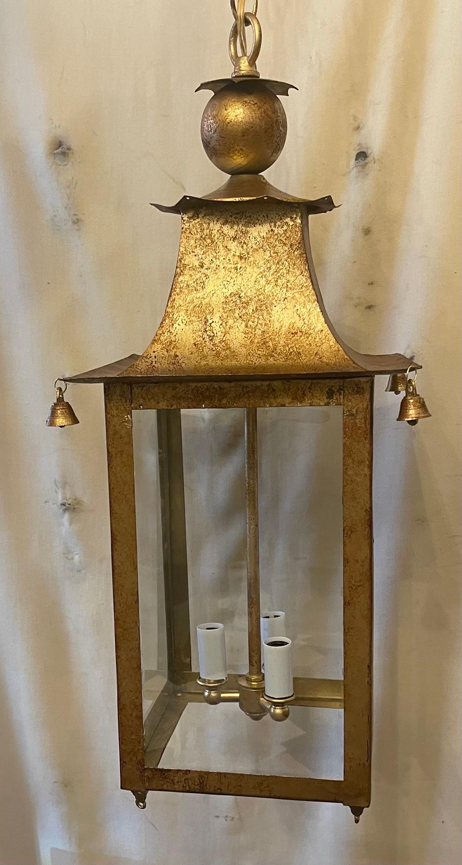 A Wonderful Pair Of Chinoiserie Gold Gilt Pagoda lantern chandeliers With 3 Candelabra Lights Completely Rewired With Bells On Each Corner, These Fixtures Come With Chain Canopy And Mounting Hardware For Installation.