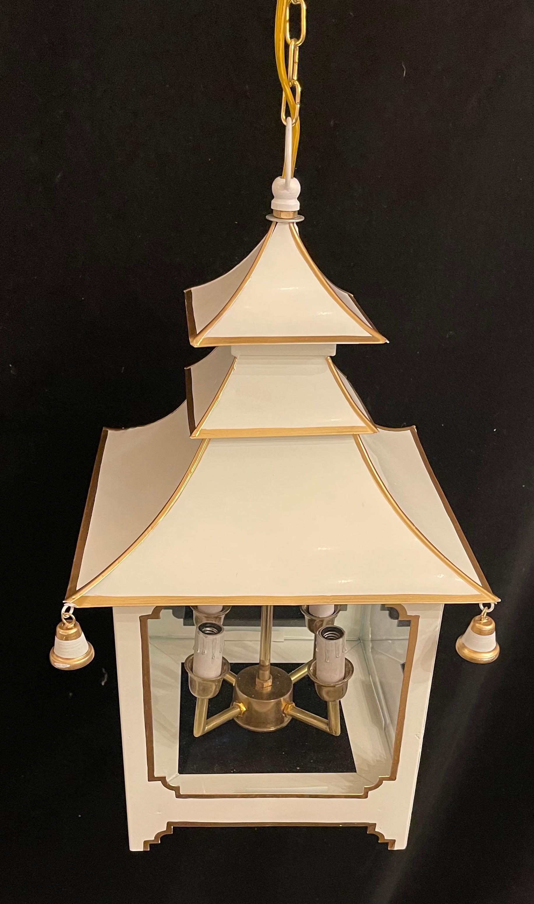 A wonderful chinoiserie pagoda form white enameled with gold trim and glass panel lantern fixture fitted with four candelabra sockets.
Accompanied by chain and canopy as well as mounting hardware for installation.

