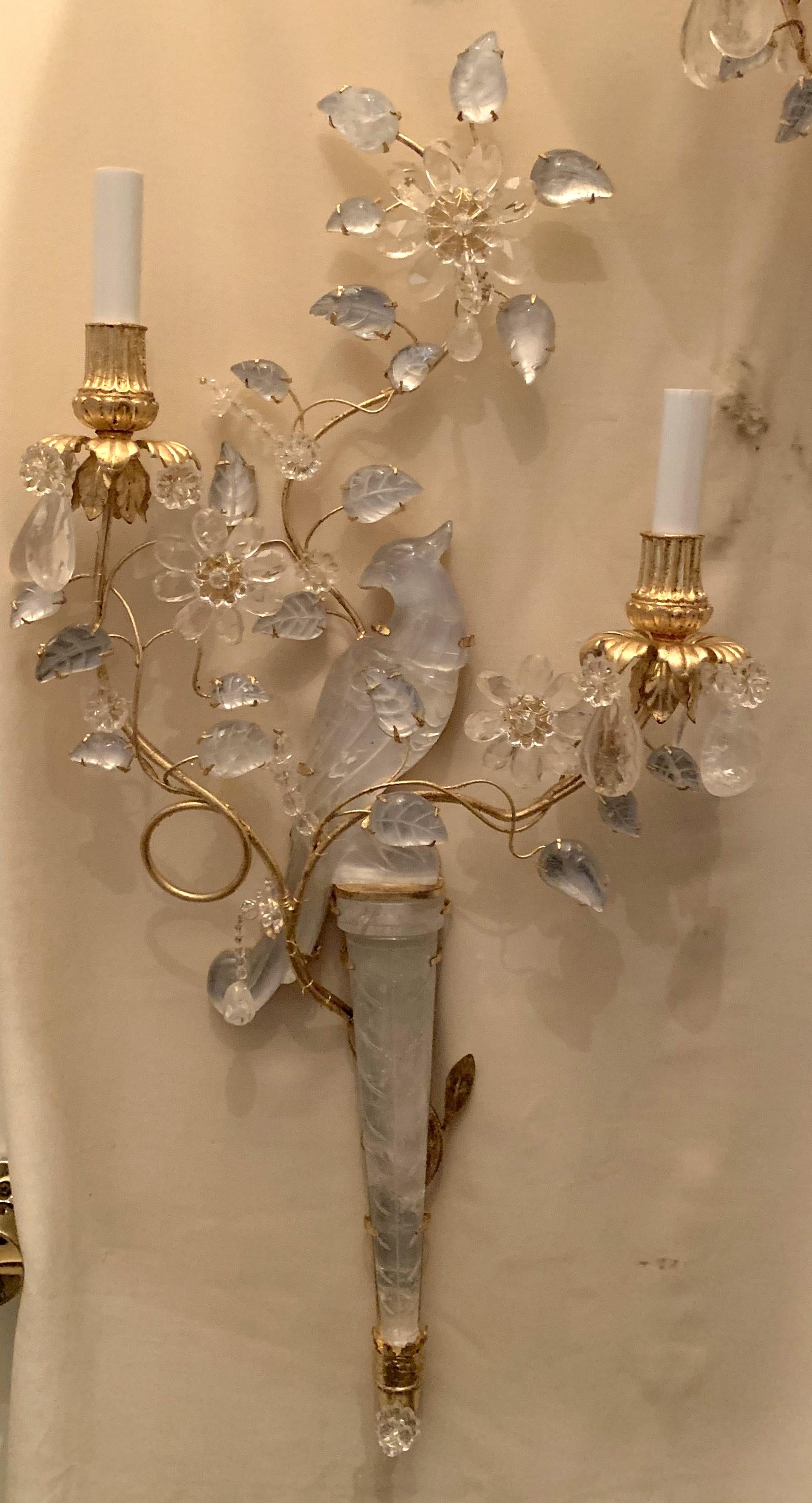 A wonderful pair of chinoiserie style rock crystal two-arm with gold gilt bird and flower form sconces facing one another.
Rewired with new candelabra sockets and ready to enjoy.