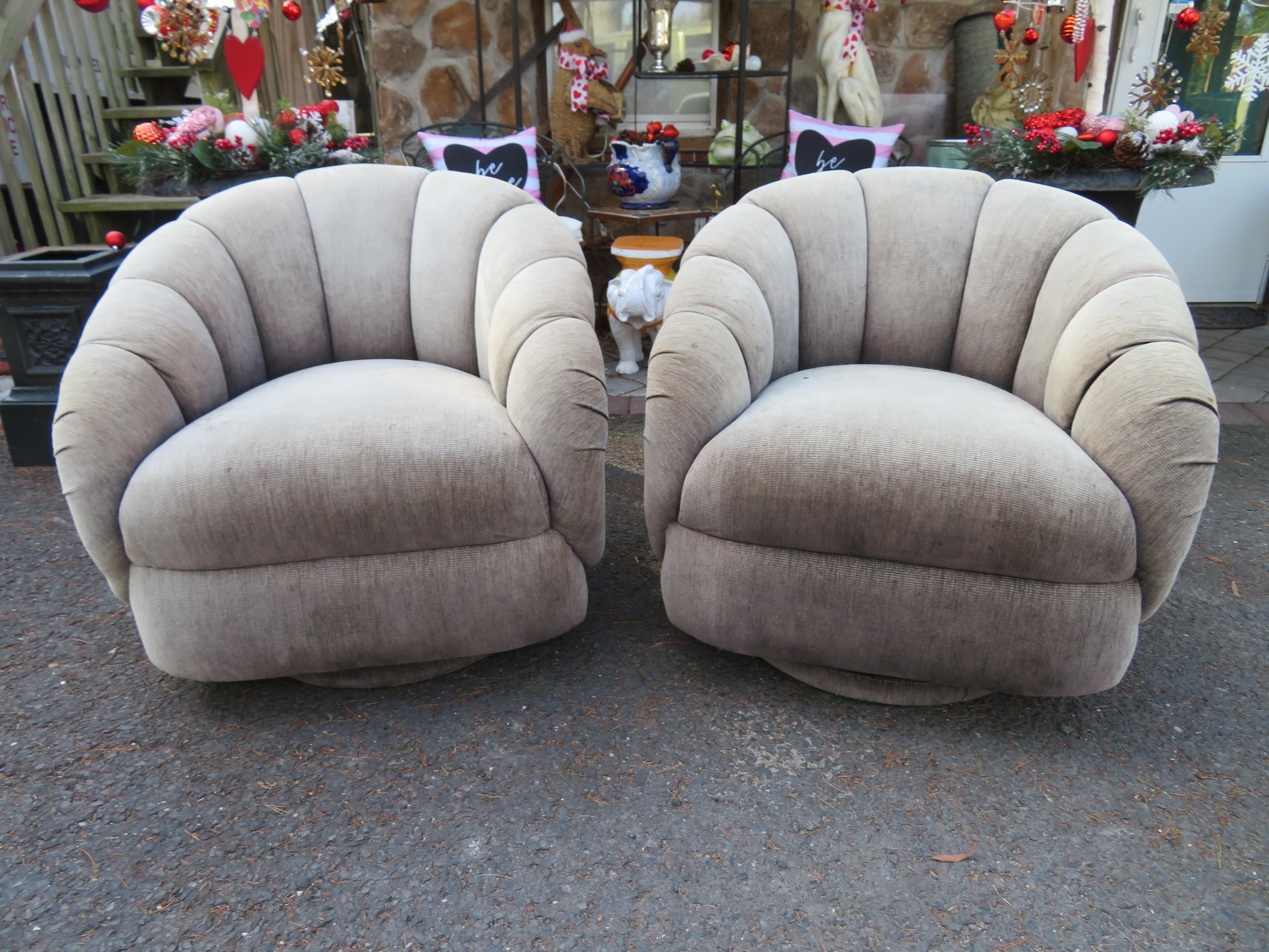Wonderful pair of croissant barrel back swivel rocker lounge chairs. We love the channel tufted barrel backs that remind us of yummy croissants along with the swivel rocker action. These will definitely need to be reupholstered but the chairs are