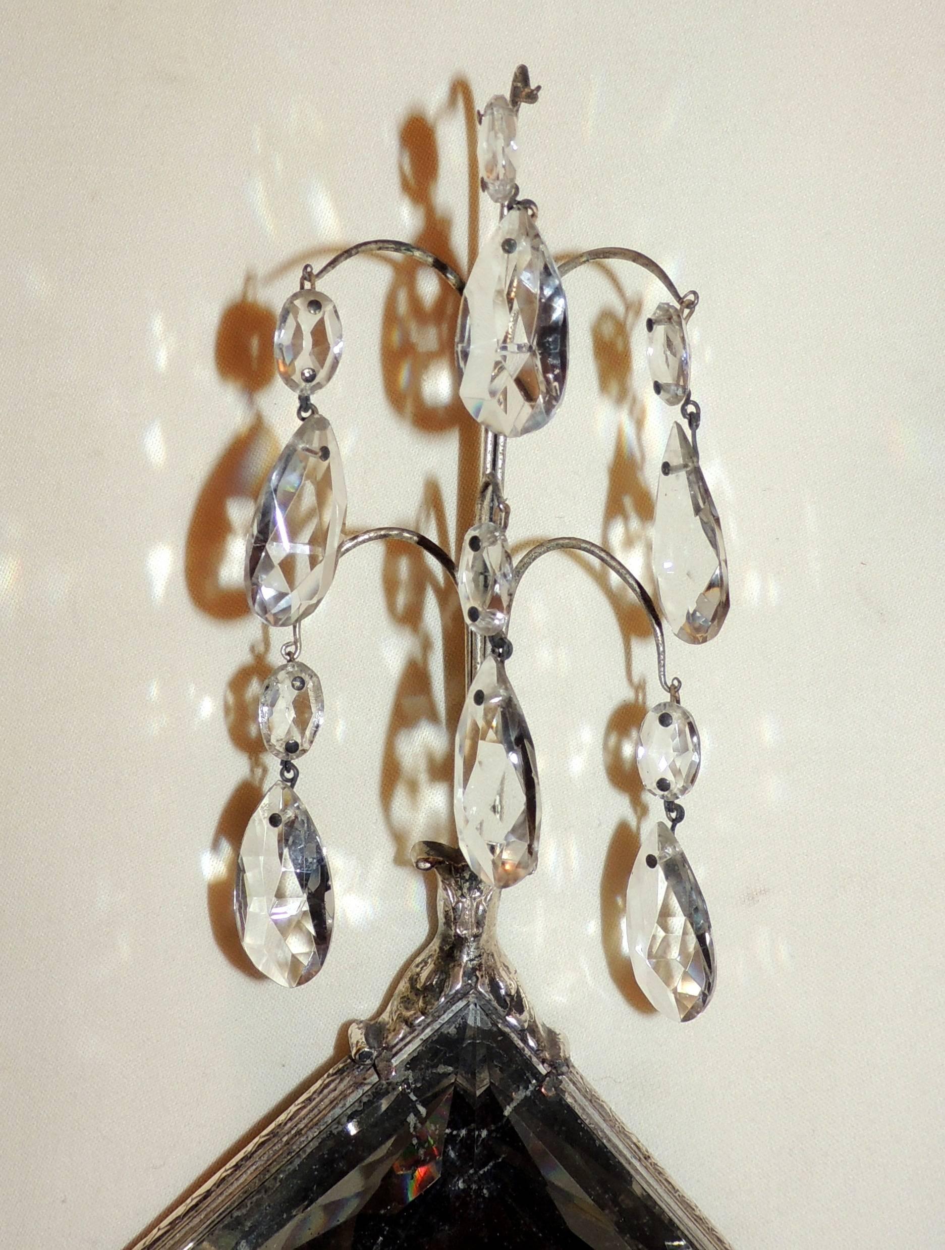 A lovely vintage pair of silvered bronze two-arm sconces with multifaceted crystal and mirror diamond centre with prisms throughout, In the manner of E.F. Caldwell marked with original local union label on back. Newly rewired and ready to