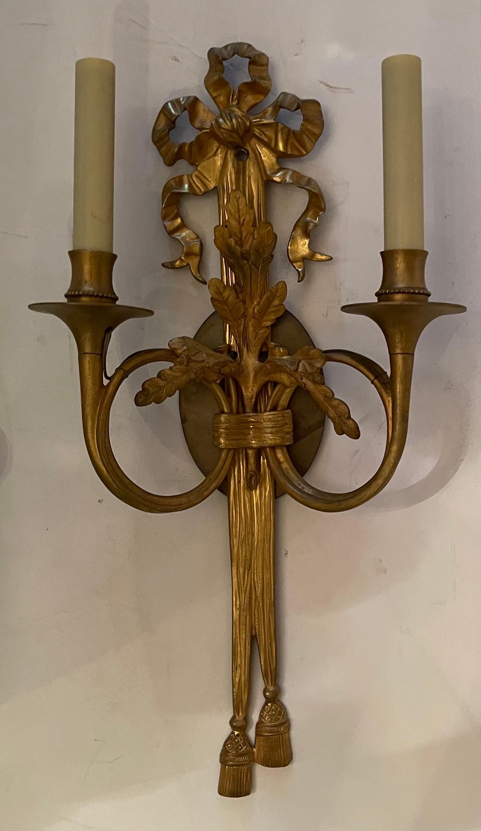 A Wonderful pair of Dore bronze french horn flute bow top & tassel two candelabra light wall sconces in the manner of E. F. Caldwell