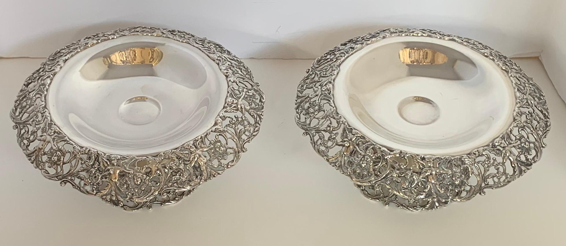 A wonderful pair of American sterling silver reticulated compotes by Durham Silver Co. featuring a pierced edge and foot with a winged cherub and lion design. These ornate compotes feature an everted top section with pierced cherub and lion masques