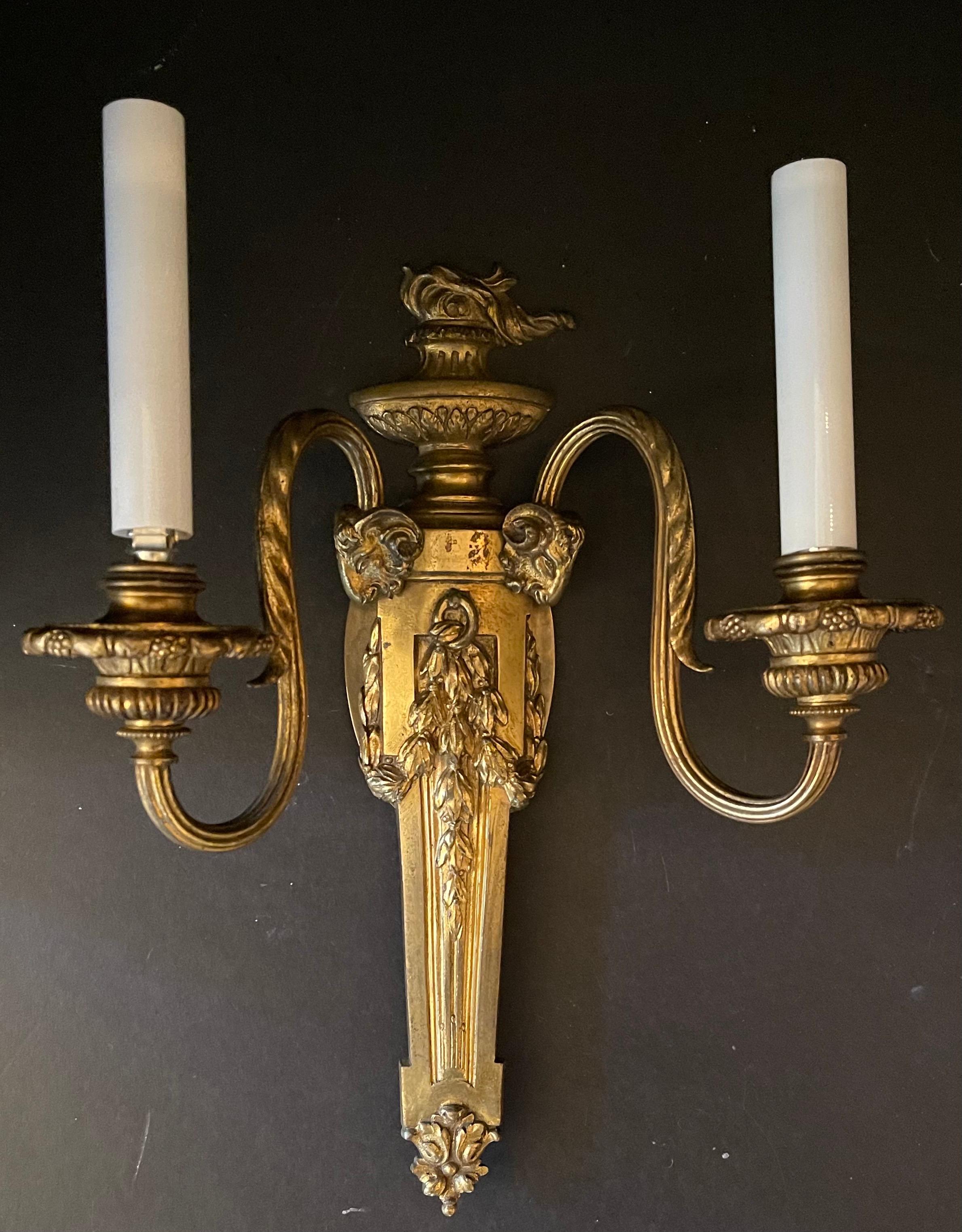 A wonderful pair of E. F. Caldwell style neoclassical bronze urn flame touchier ram's head two-arm sconces
Rewired and comes with mounting hardware, ready for installation.