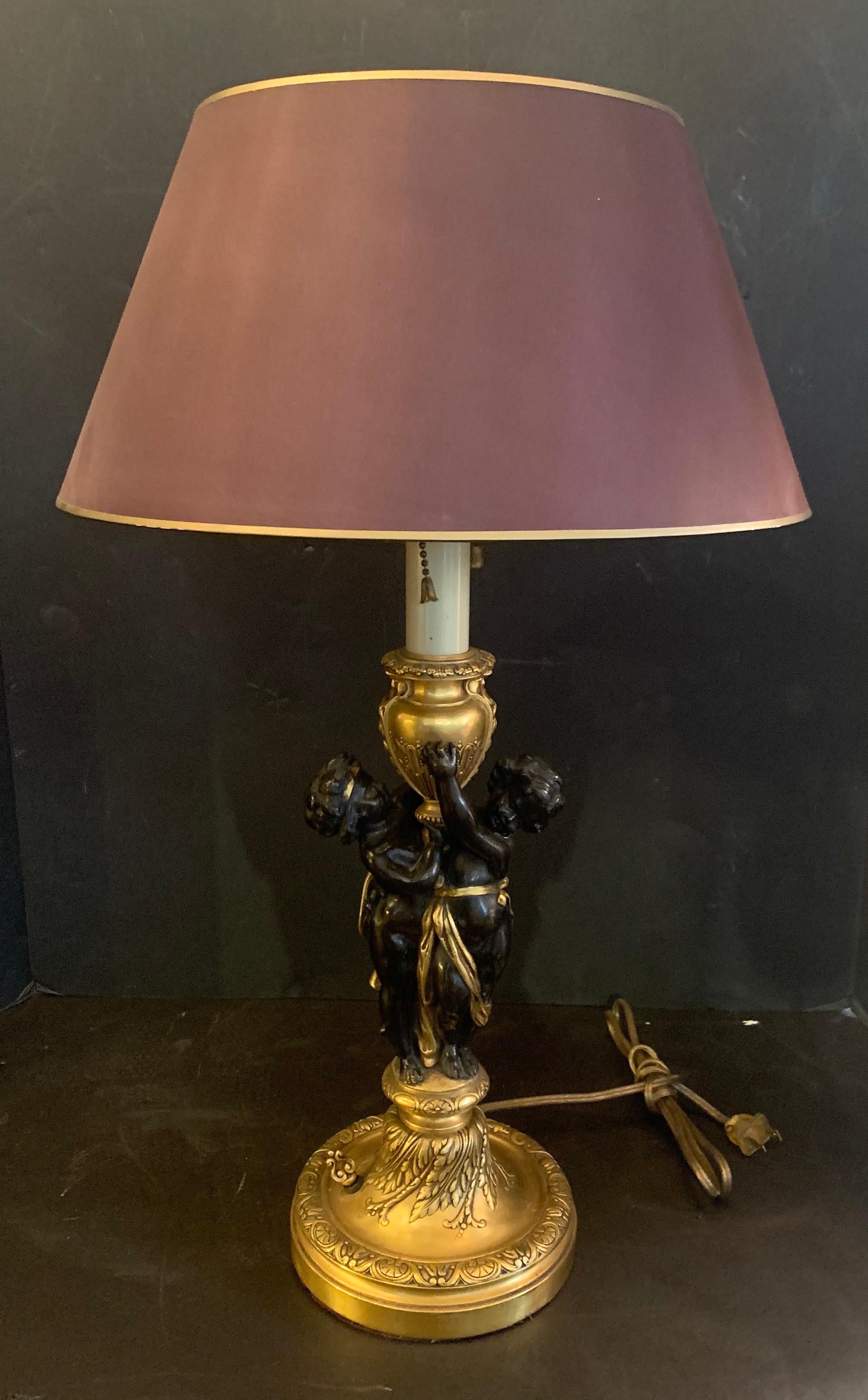 A rare and wonderful pair of E.F. Caldwell Stamped, French bronze patinated and gilt putti / double cherub figures holding up an urn lamps, rewired and accompanied by silk covered shades.
Superb quality!
 
With shade: 14