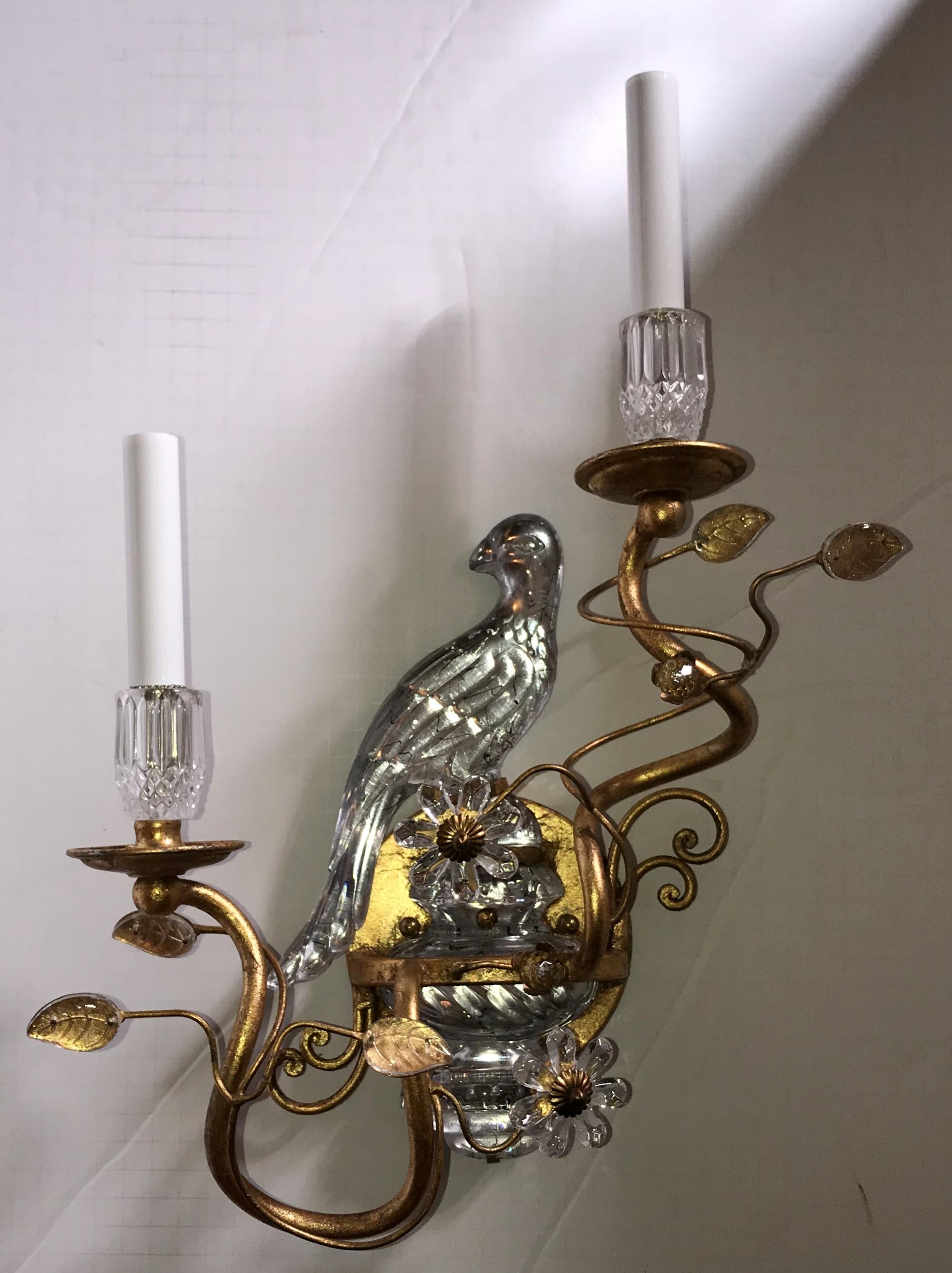 A wonderful pair of faux rock crystal or glass bird sitting on urn form gold gilt sconces in the manner of Bagues.