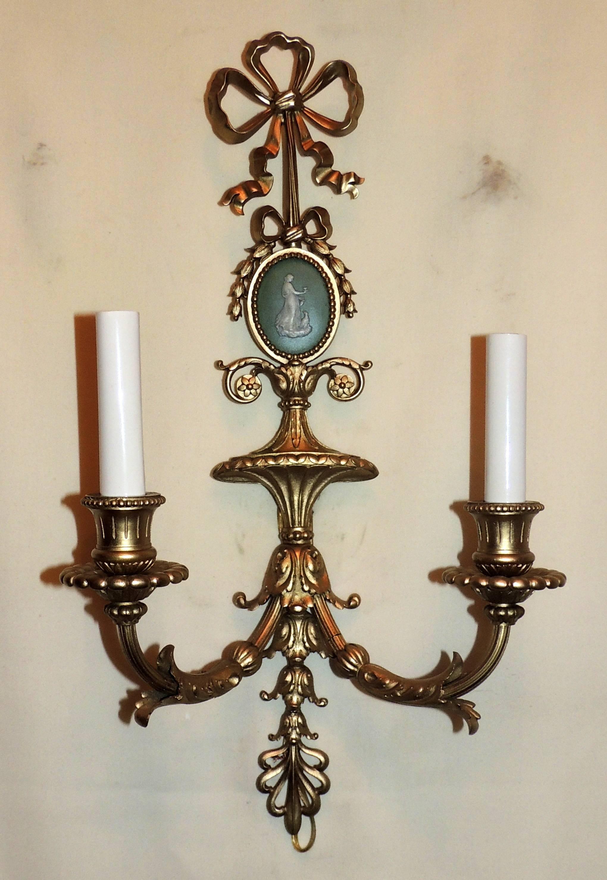 A wonderful pair of French green Wedgwood plaque and gilt bronze bow top wall sconces, each with two candelabra lights and a central jasper ware medallion of oval shape with a female figure in classical dress. 
Approx. 19.5