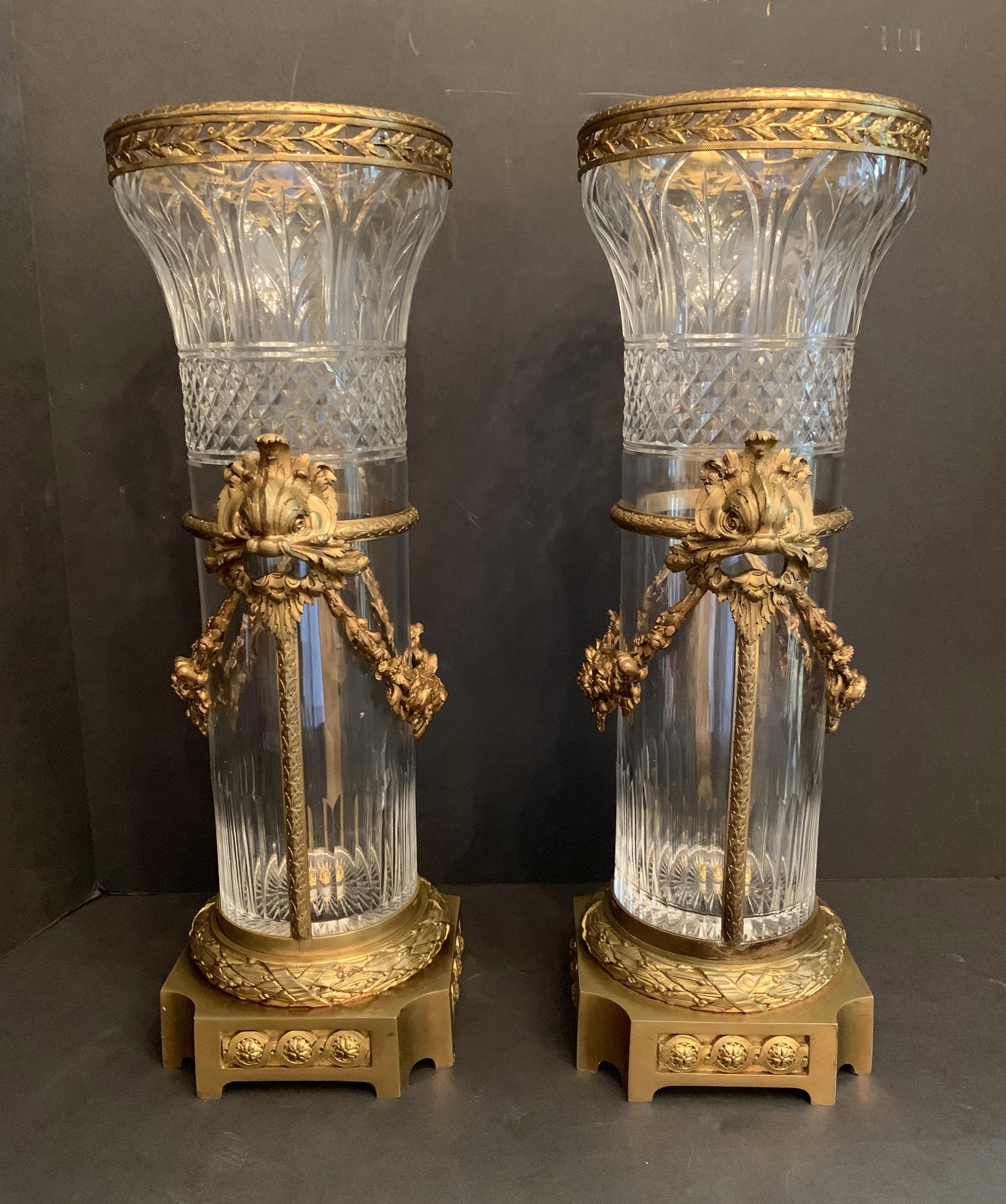 A wonderful pair of French Dore bronze and cut crystal baccarat style ormolu mounted dolphin swag vases.