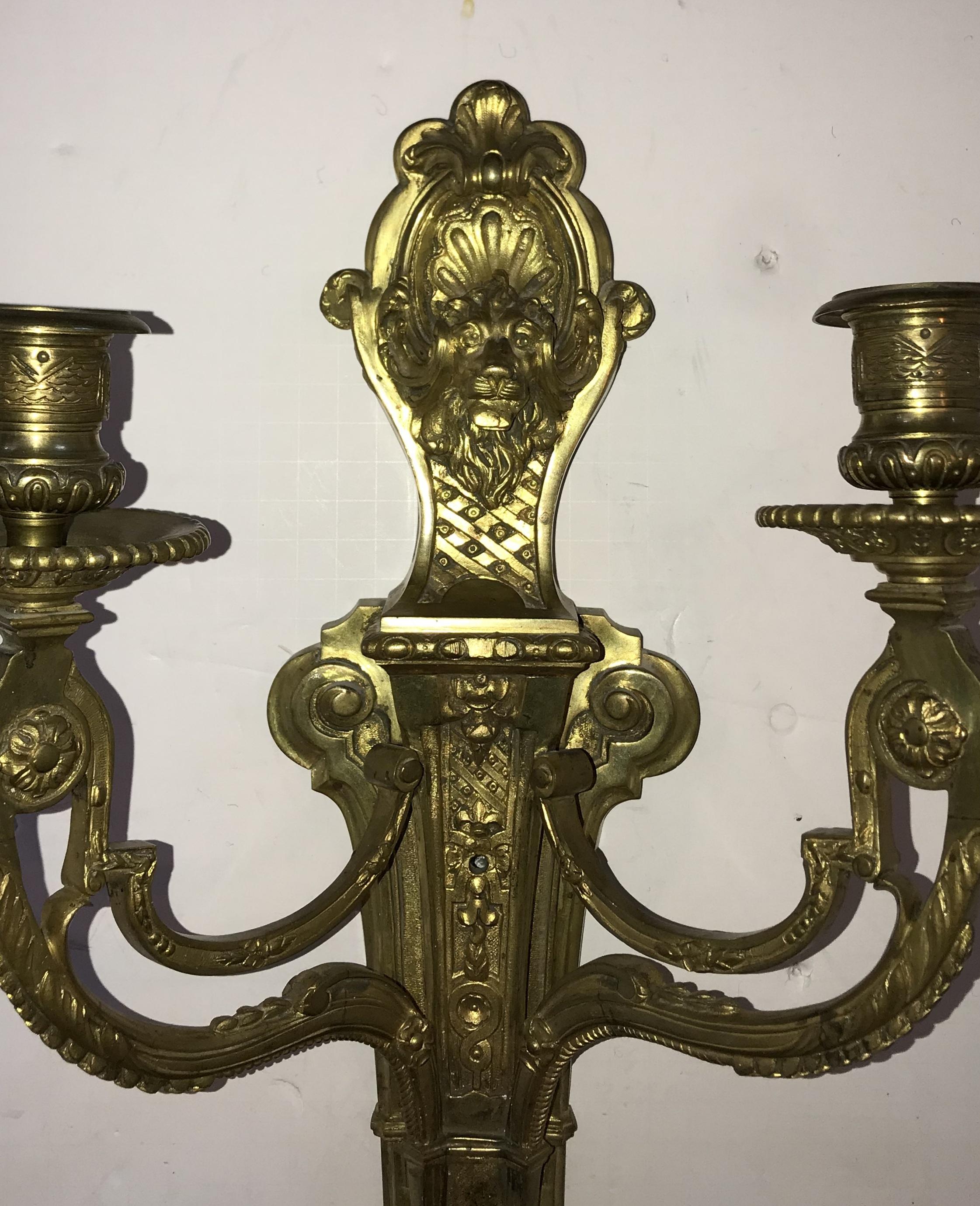 A wonderful pair of French bronze lion and medusa mask neoclassical / Regency sconces.