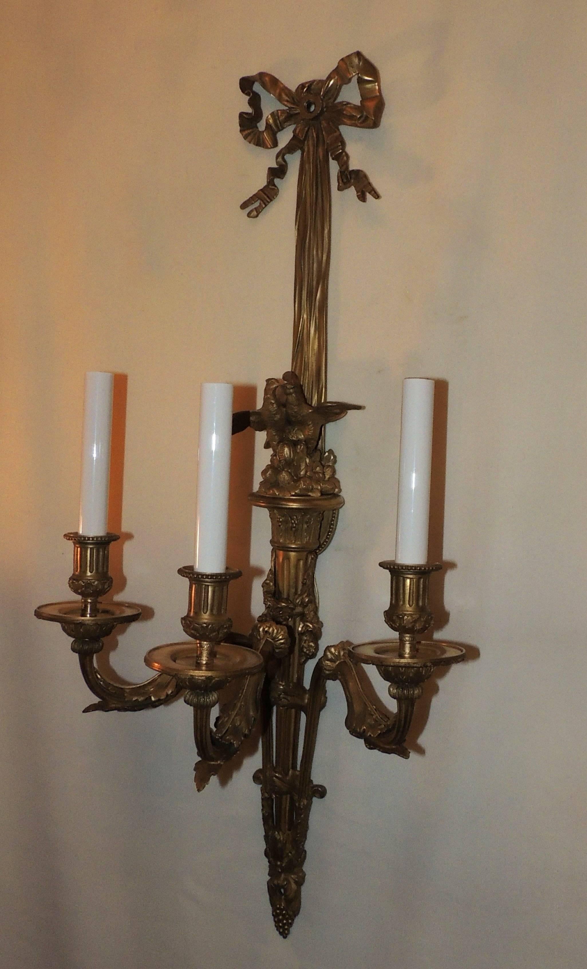 Early 20th Century Wonderful Pair French Dore Bronze Bow Love Birds Tassel Swag Three-Arm Sconces For Sale